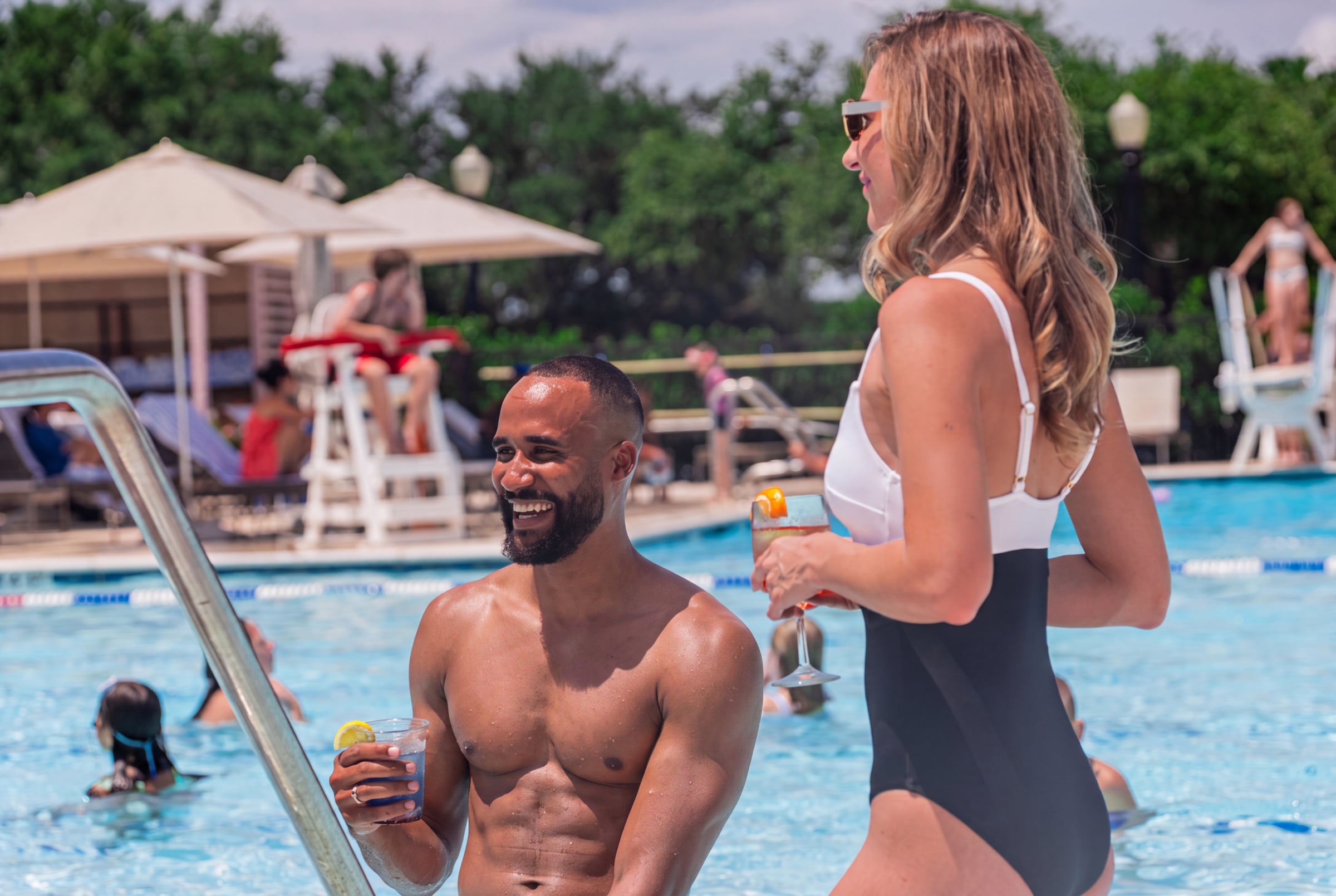 Husband and wife enjoying a day at the pool