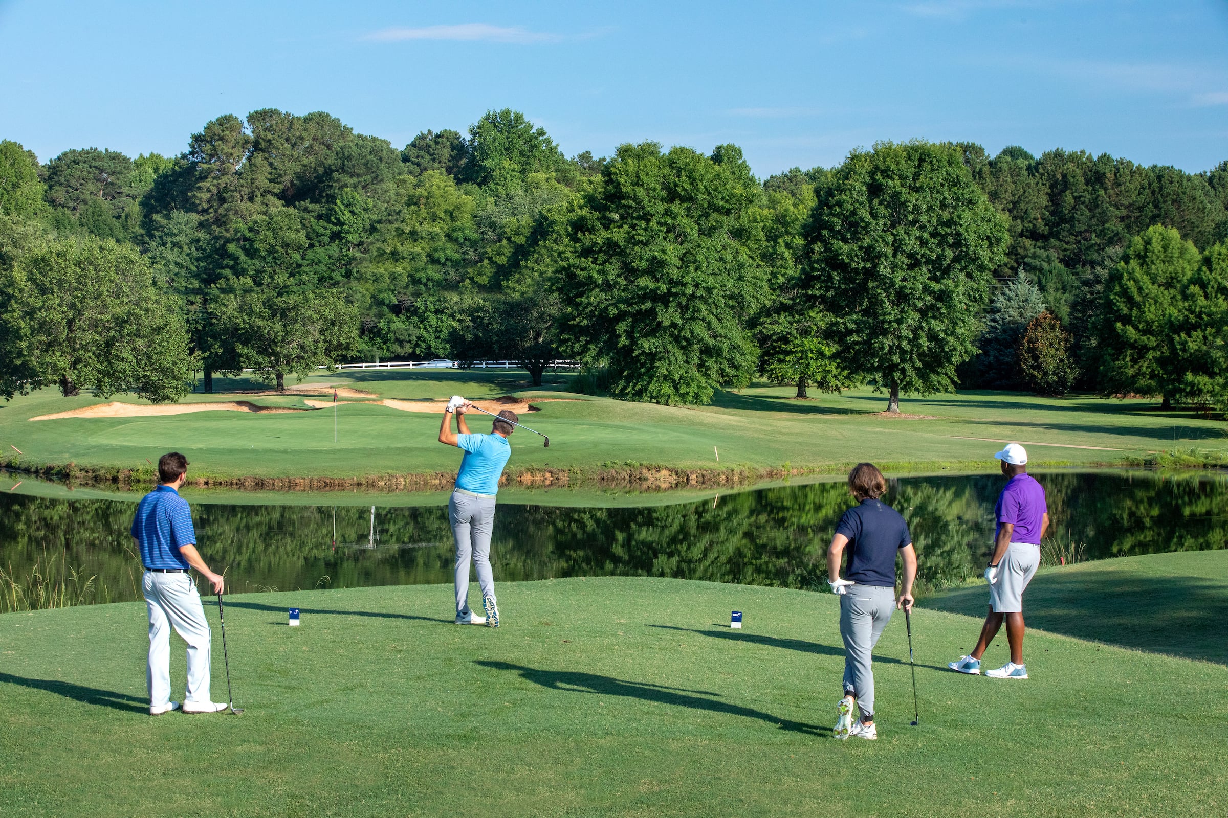 four golfers on course