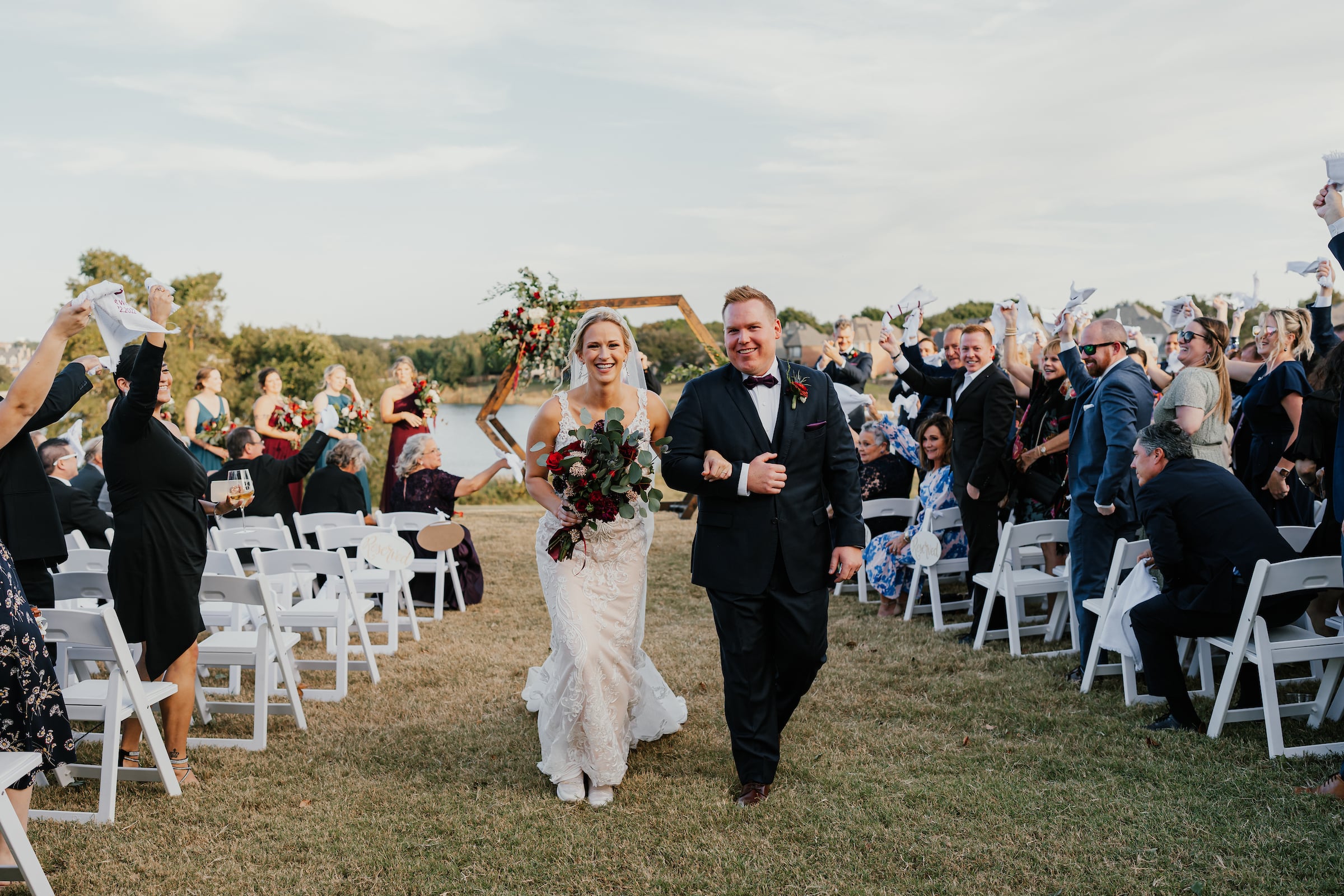 a wedding ceremony with bride and groom walking down the aisle