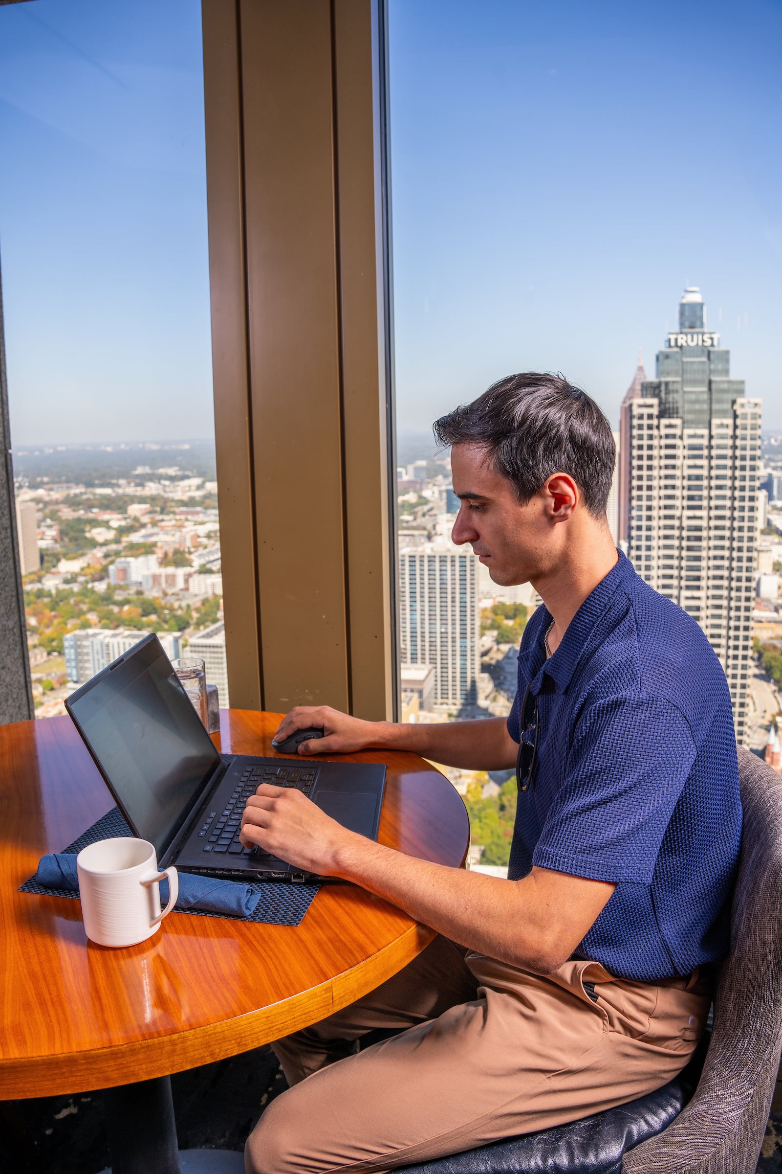 Man seated at a table with his computer