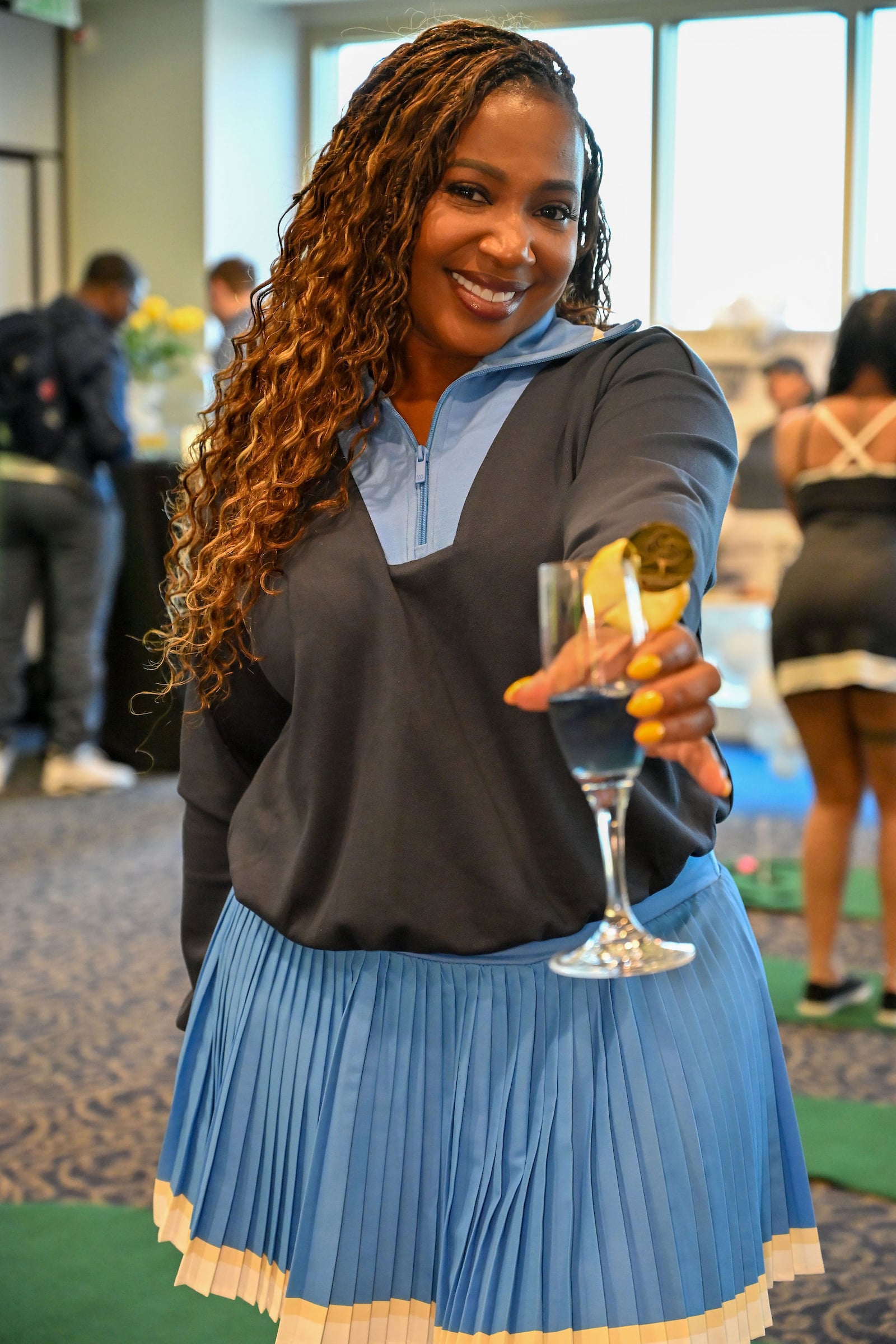 Smiling woman holding out a glass of champagne