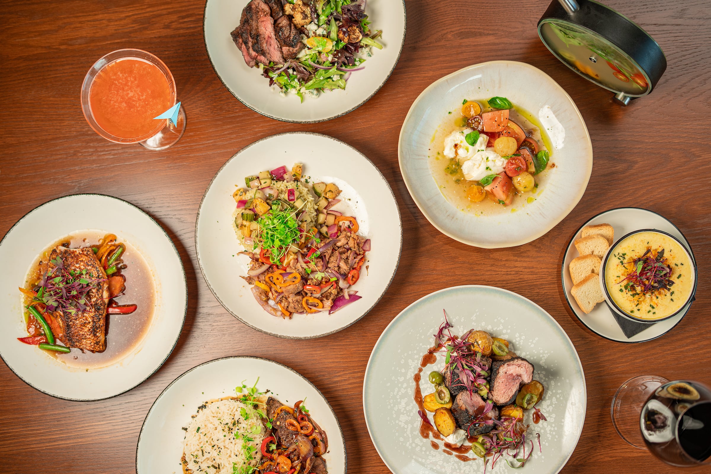 Overhead view six plates of food & a drink