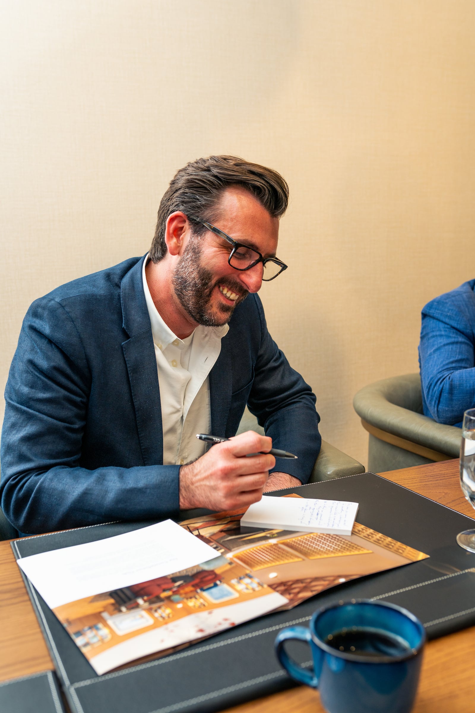 Man smiling while in a meeting