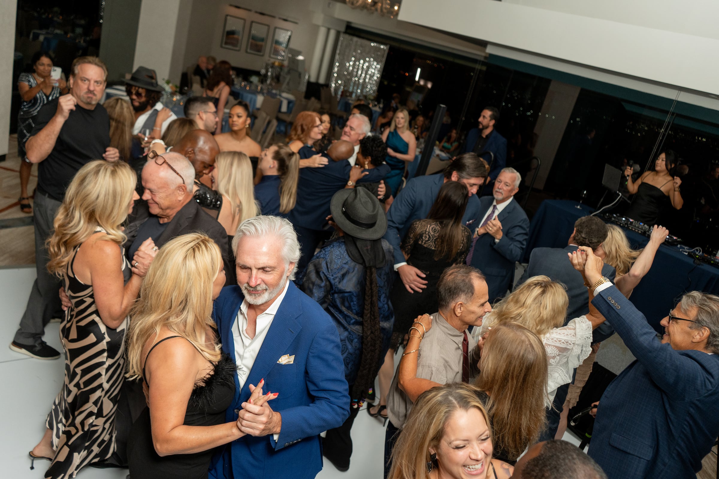 Large group of people dancing at a private event