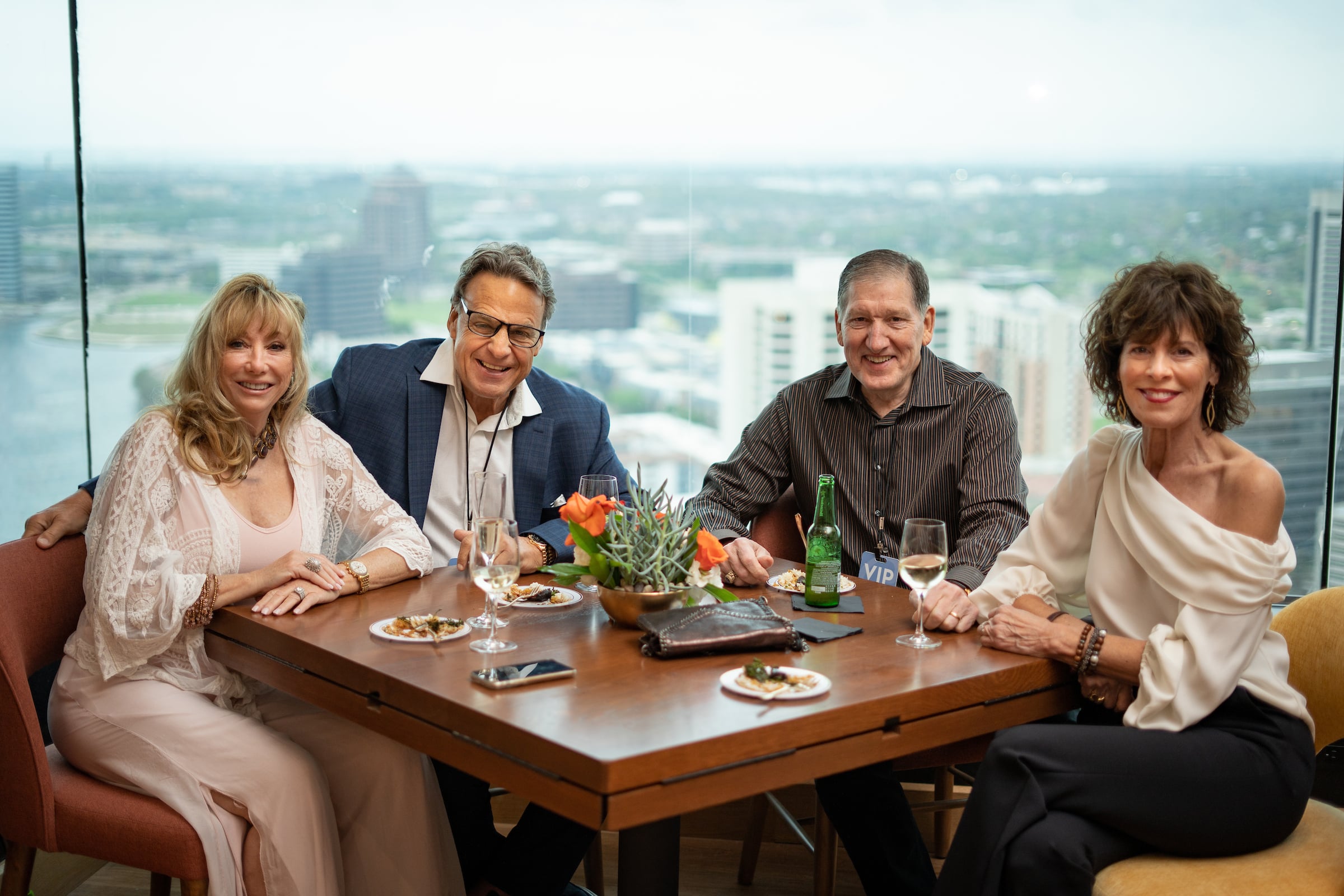 Two couples dining posing for a picture