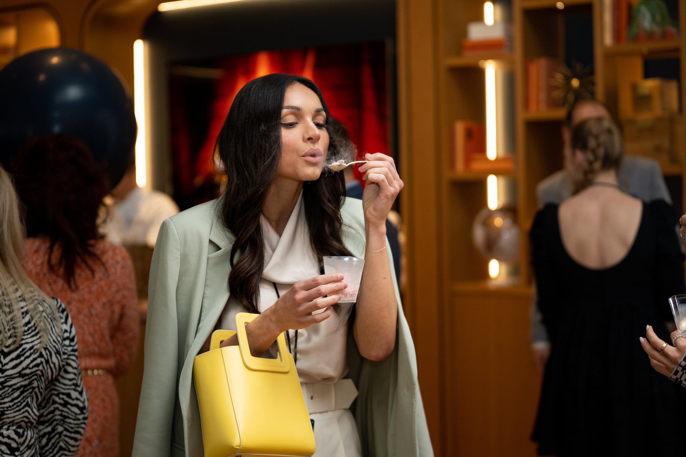 Woman taking a bite of an appetizer at a private event