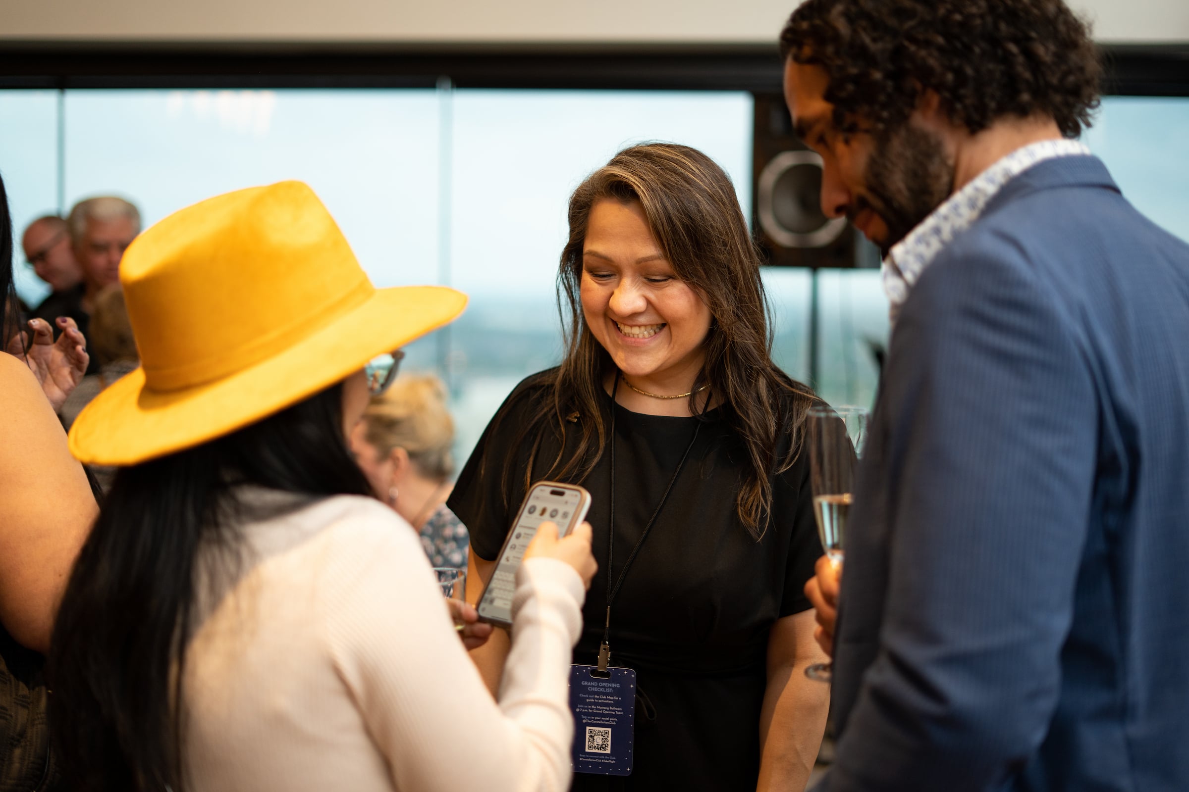 Two women & a man talking at a private event
