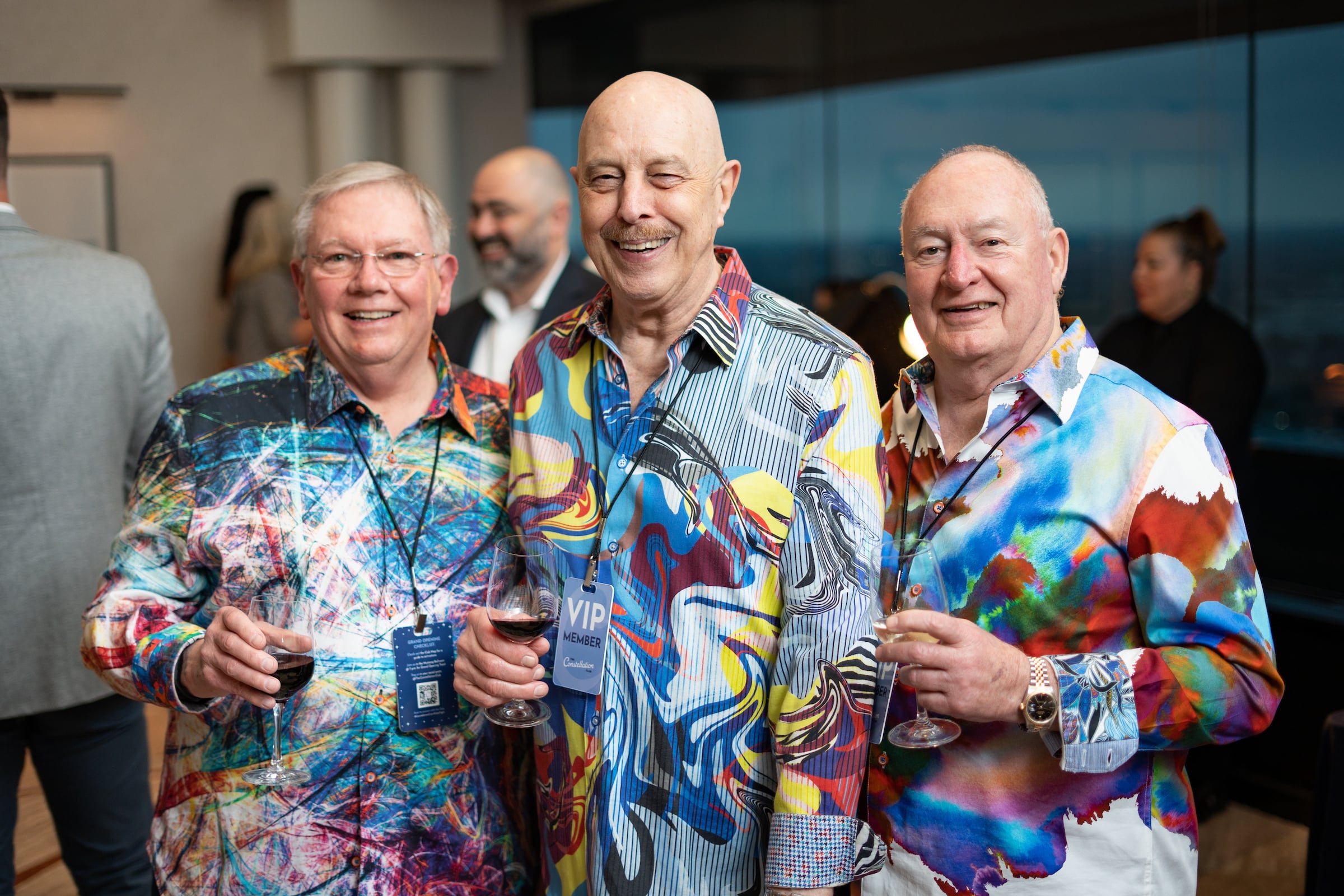 three men in psychedelic design shirts at a private event