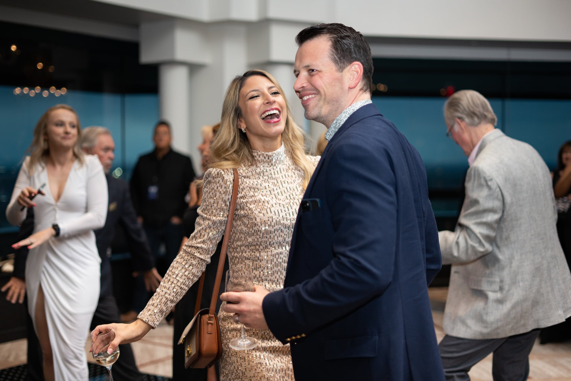 Woman laughing & man smiling at a private event