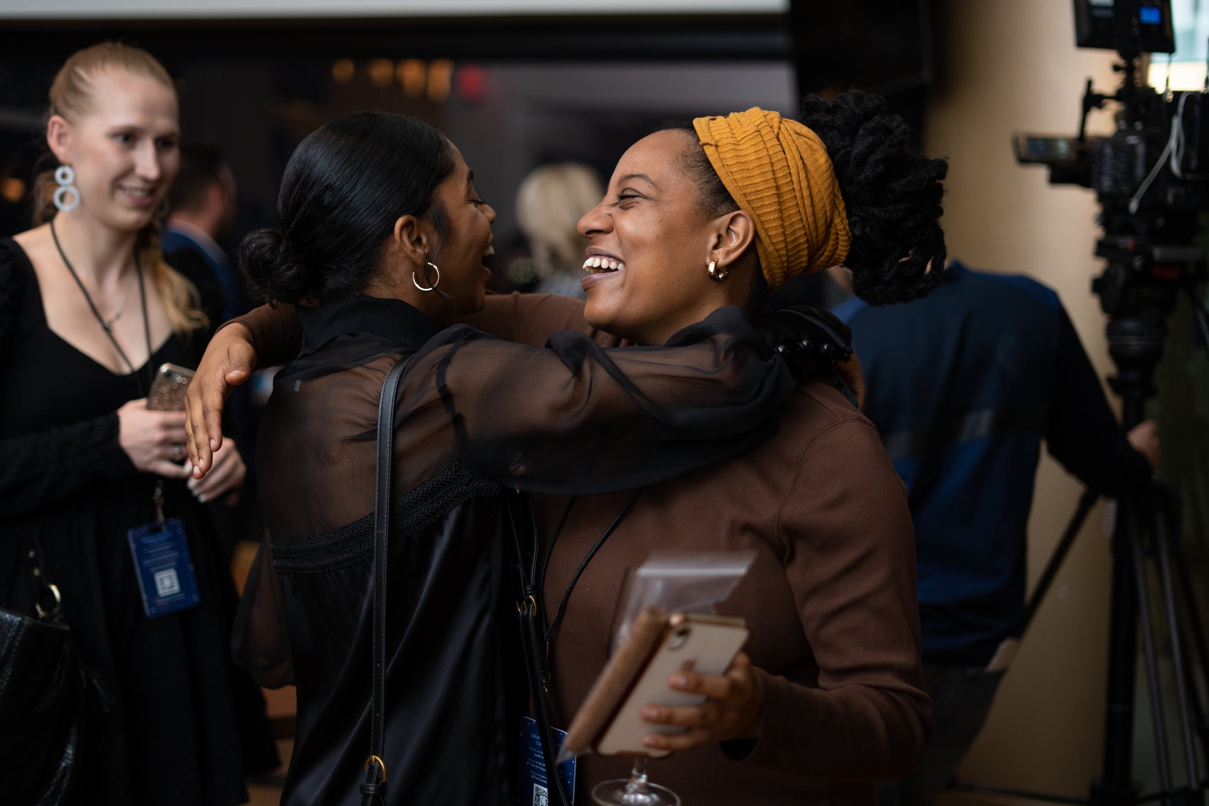 two women hugging & laughing