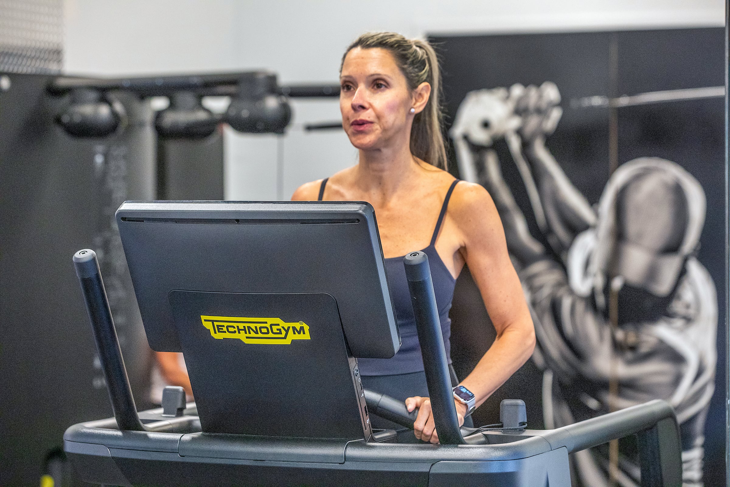 Woman using a technogym machine