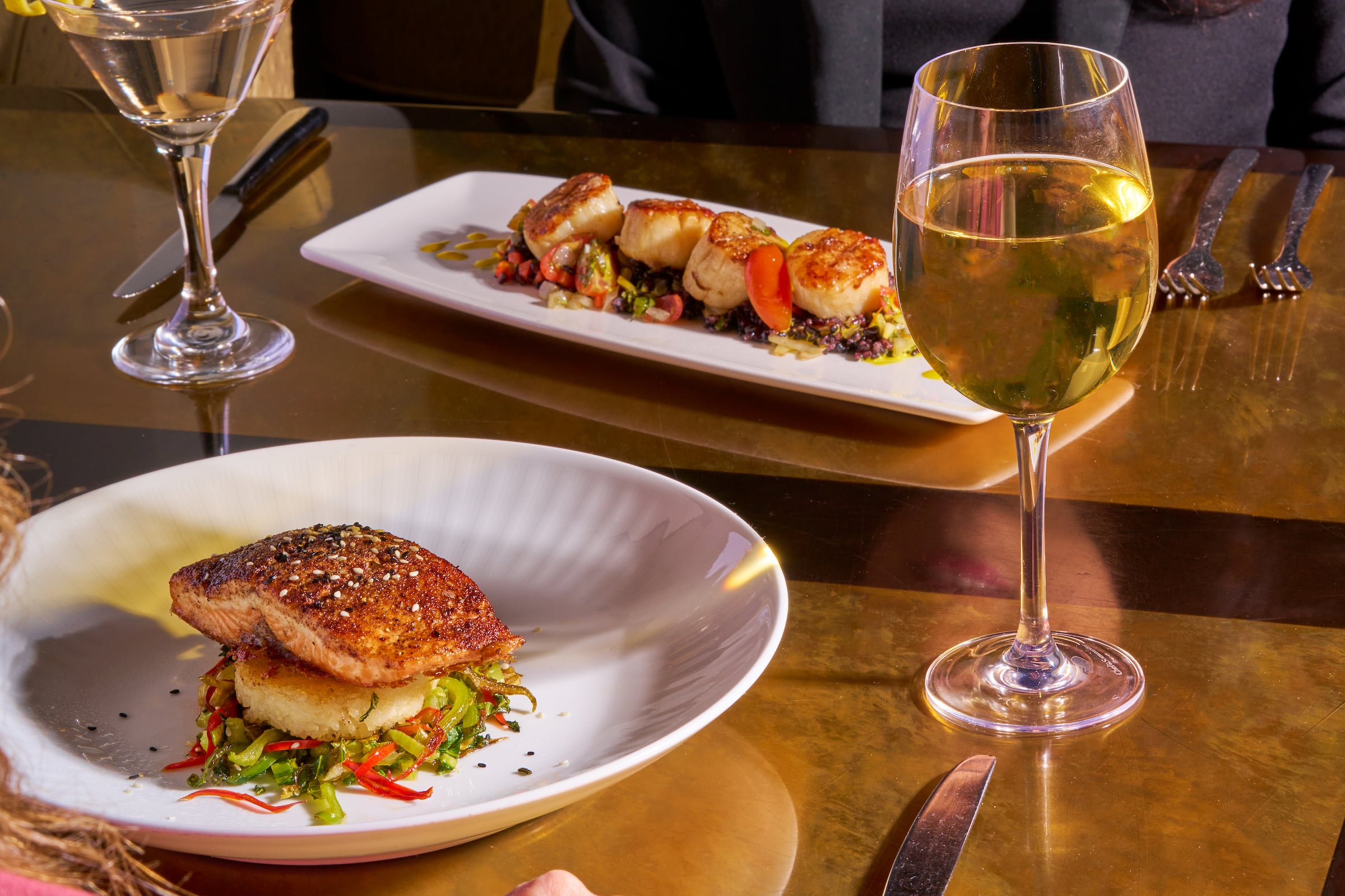 Two plates of food & two glasses of wine