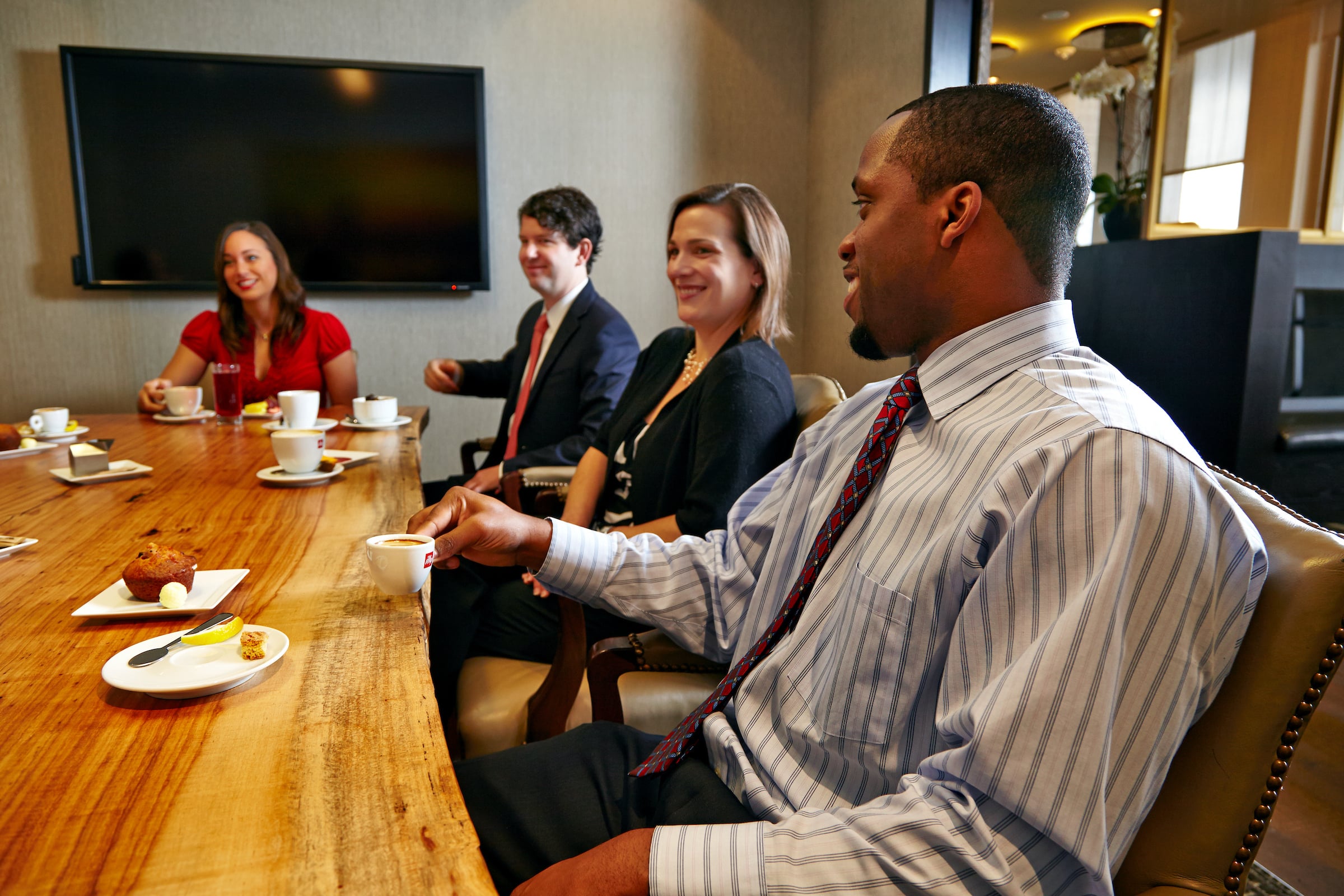 Two men & two women seated in a meeting
