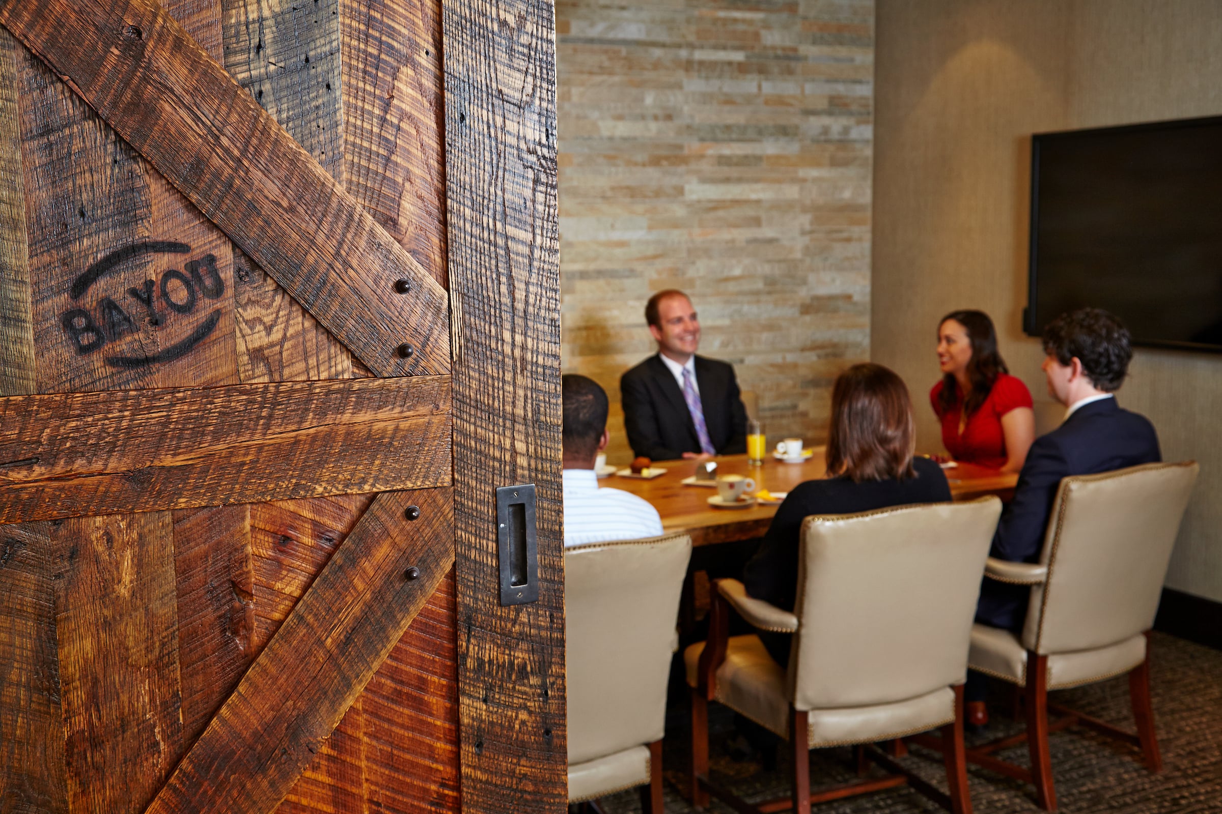 People having a meeting in the Bayou Room at The Houston Club