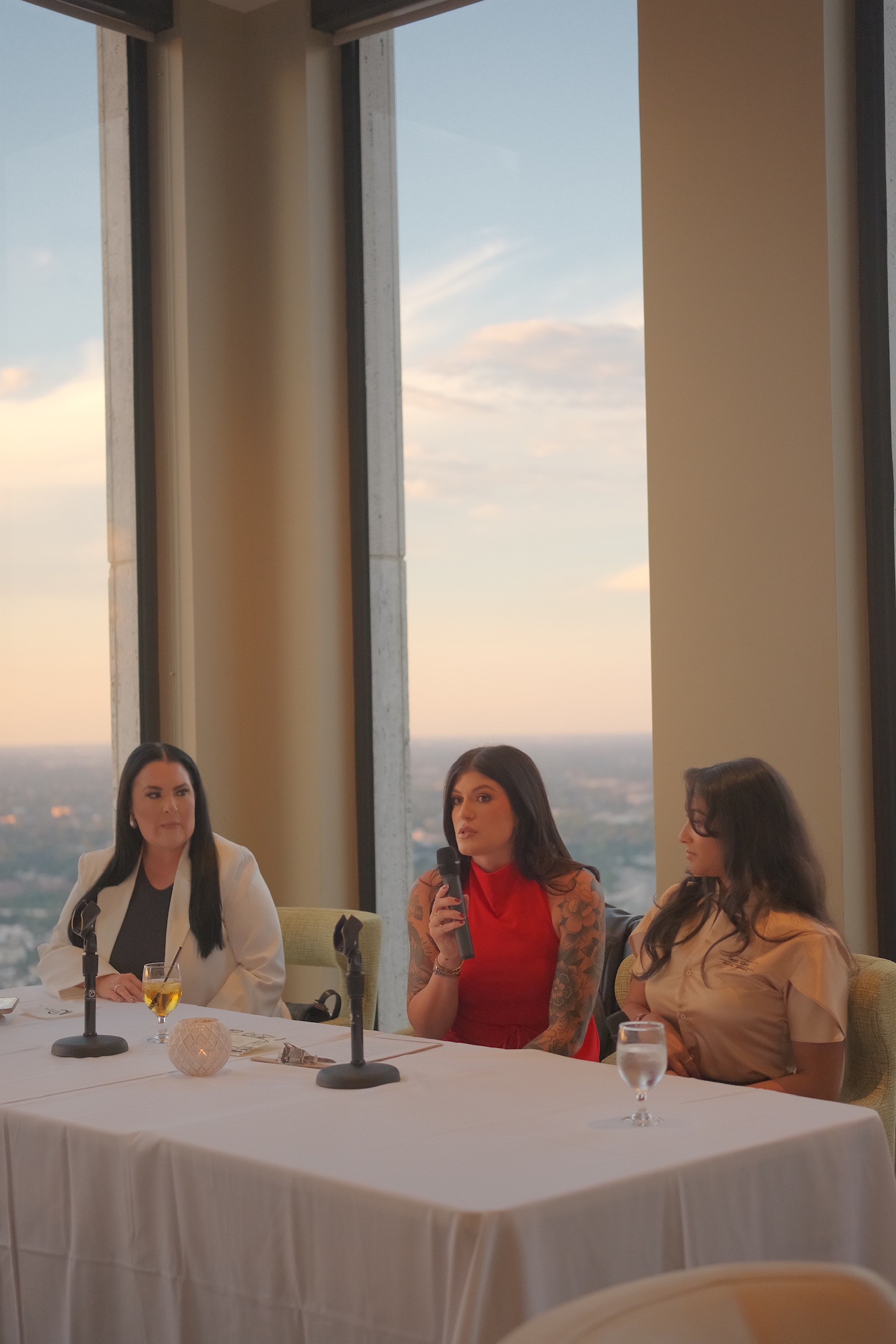 Three women seated at a private event
