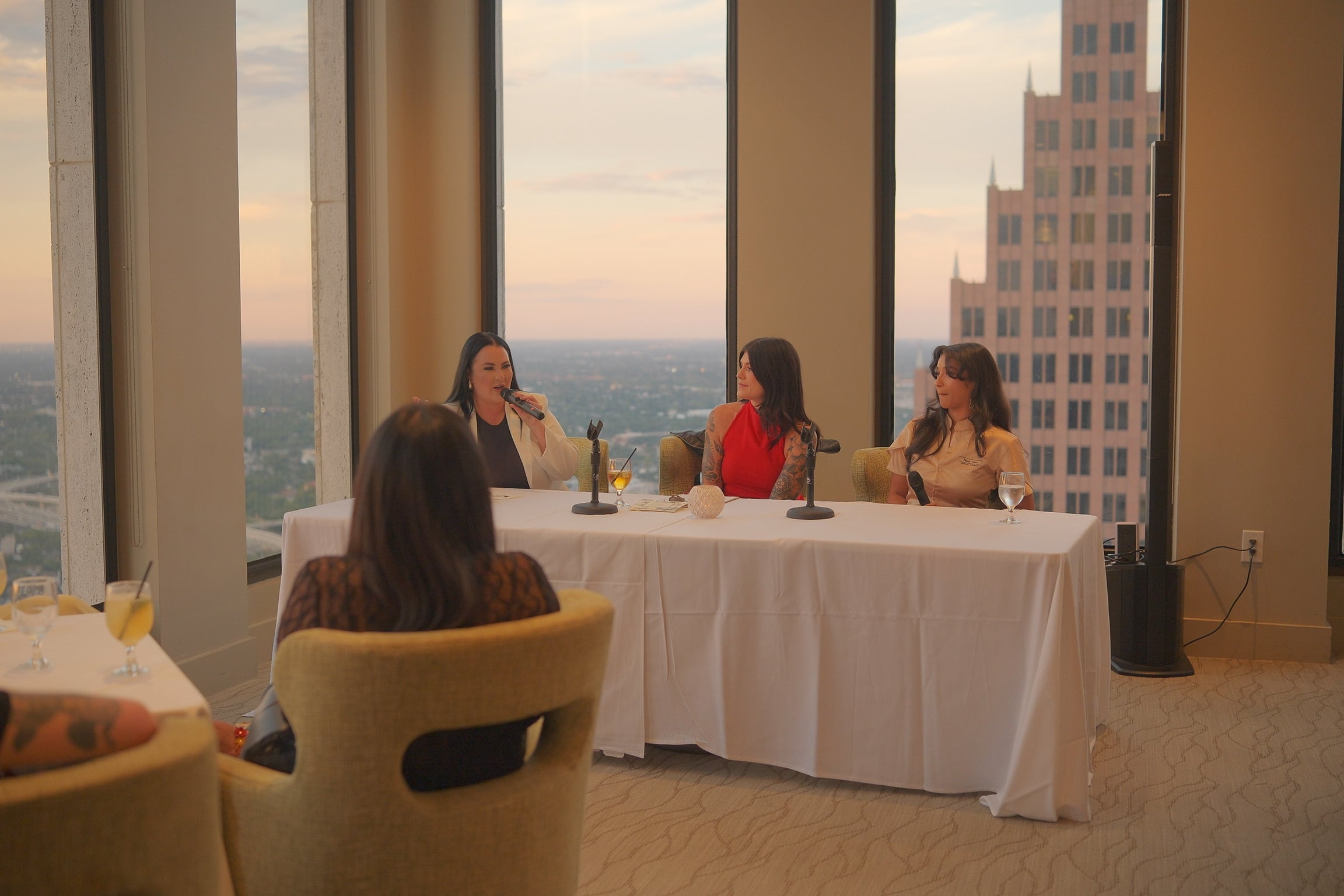 Women speaking at a private event