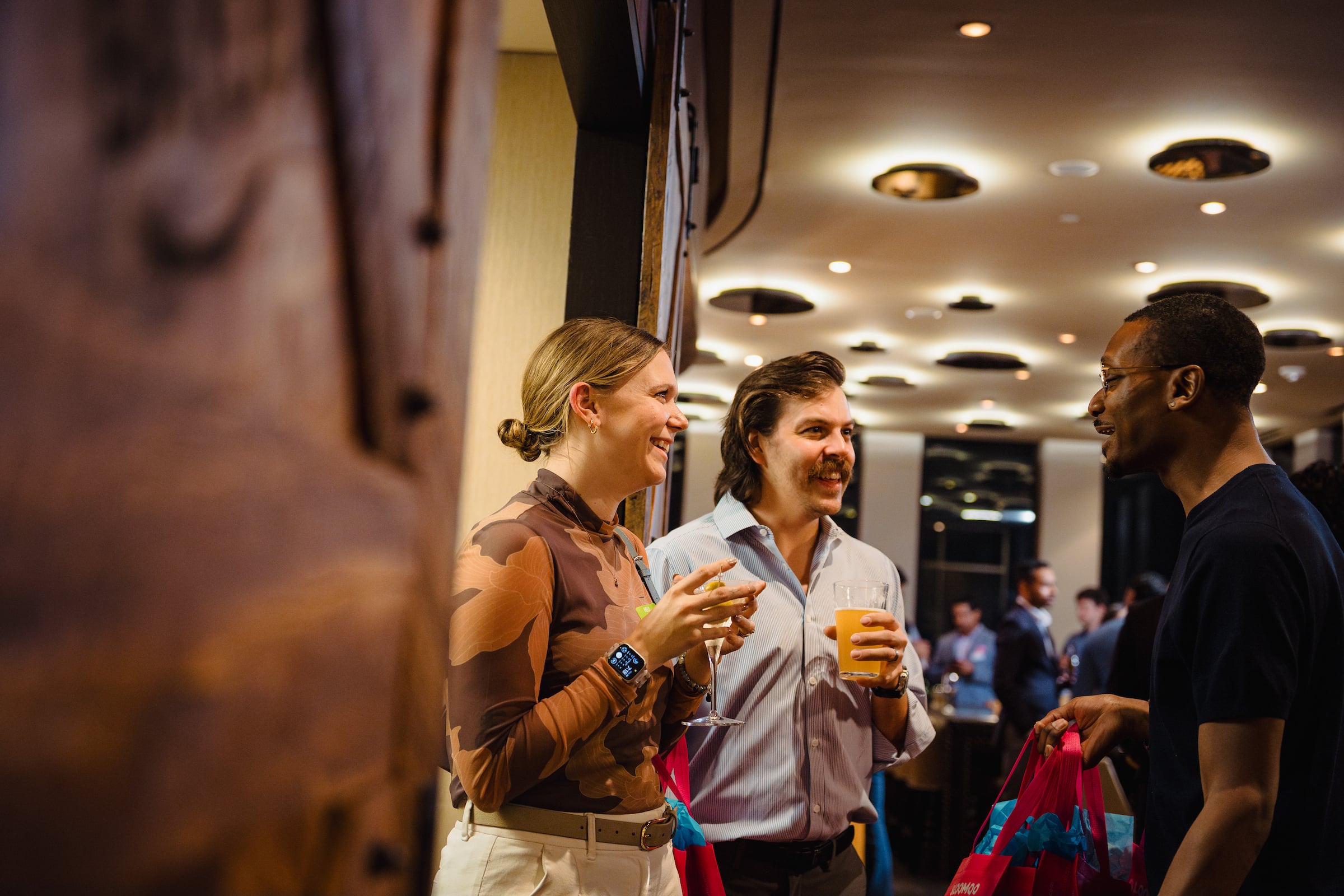 Woman & 2 men speaking at a private event