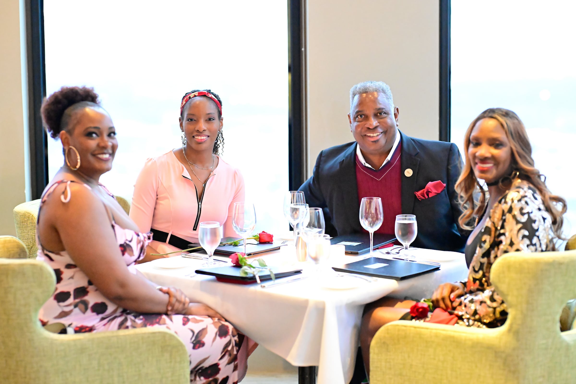 Three women & a man seated for a private event lunch
