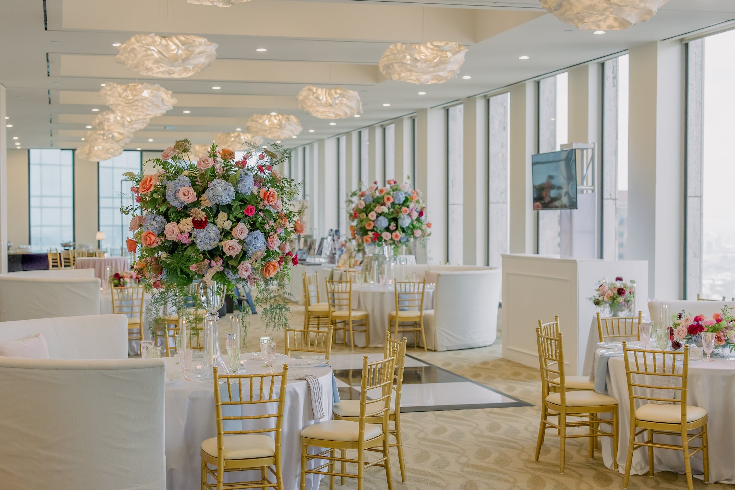 Bush Ballroom at The Houston Club set up for a private event with tall flower arrangements