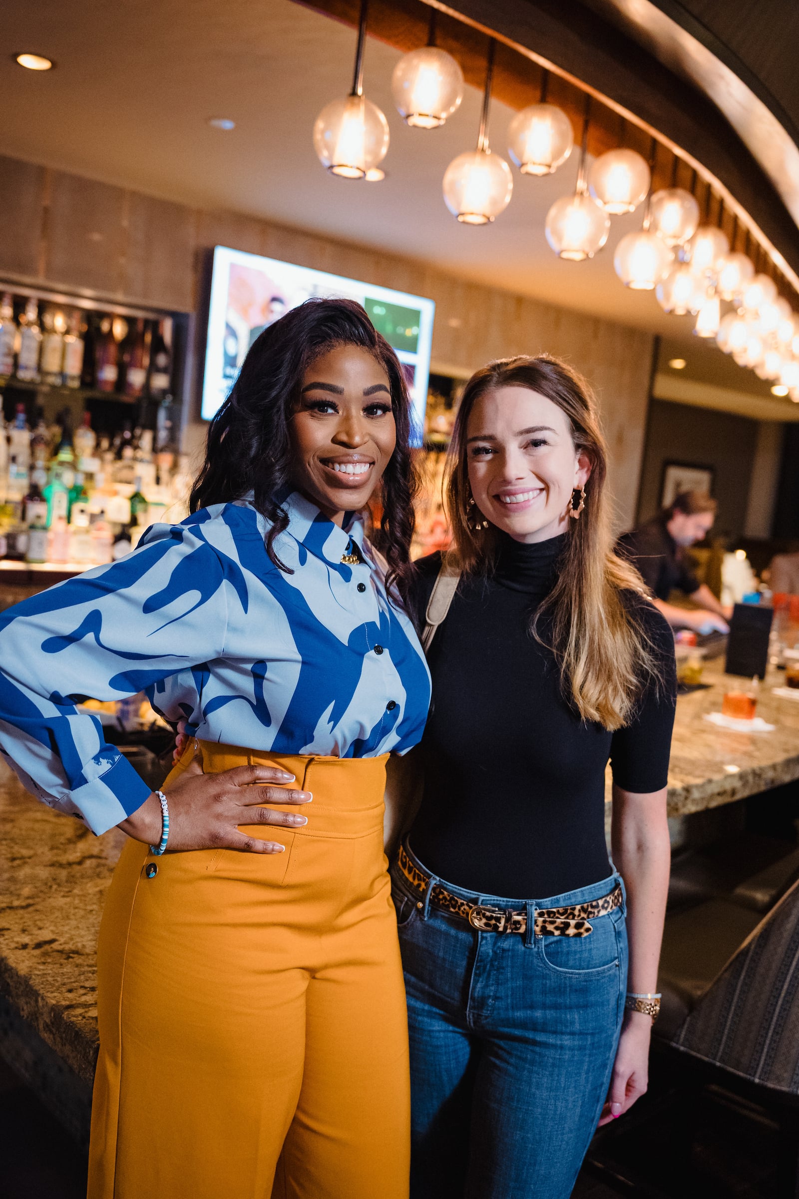 Two women photographed at private event at The Houston Club