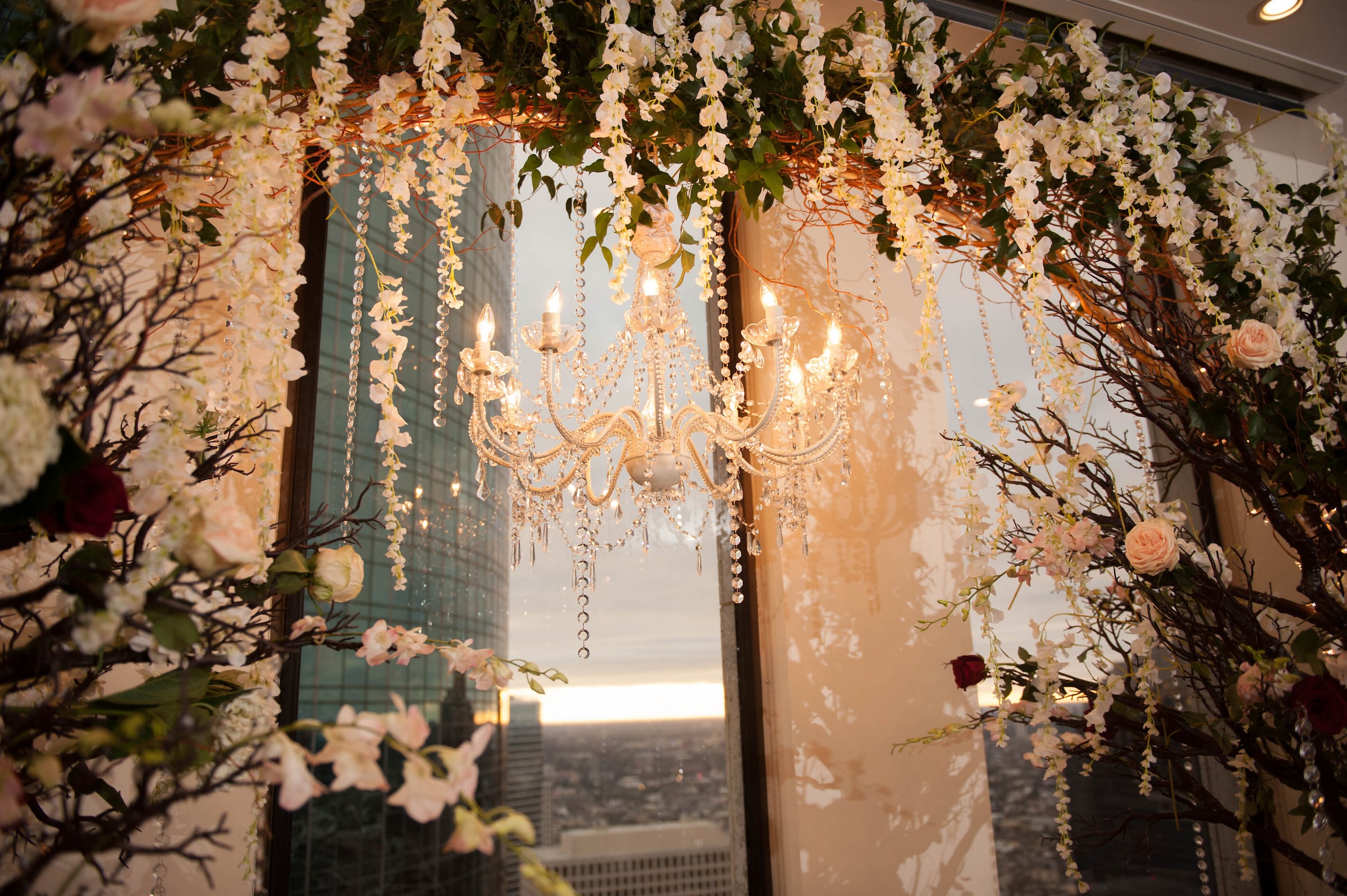Floral Wedding Ceremony Arch in front of windows