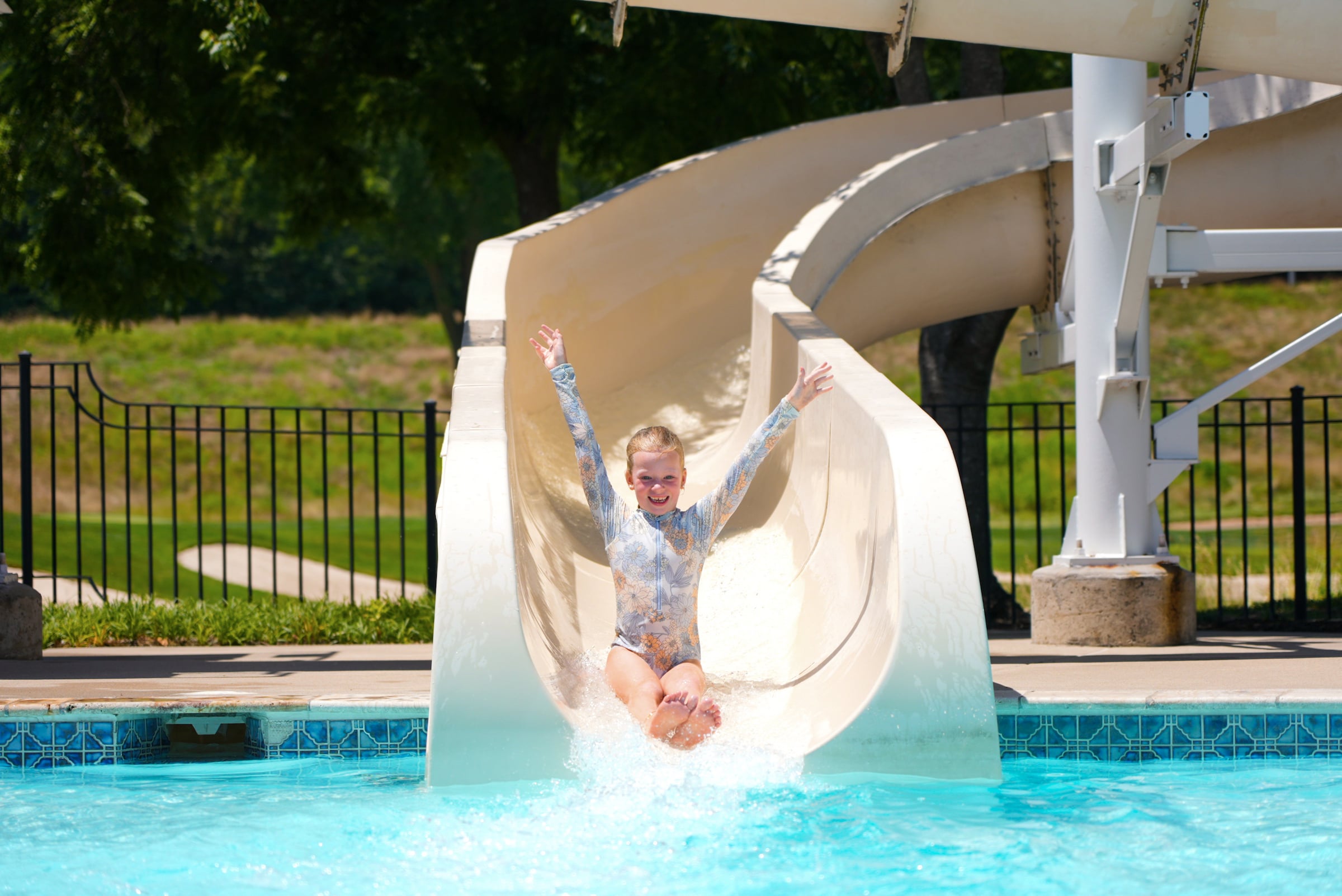 child on pool slide