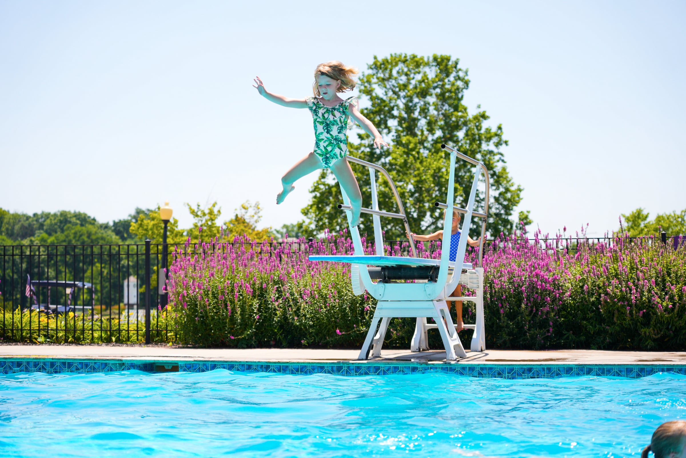 Girl jumping off diving board