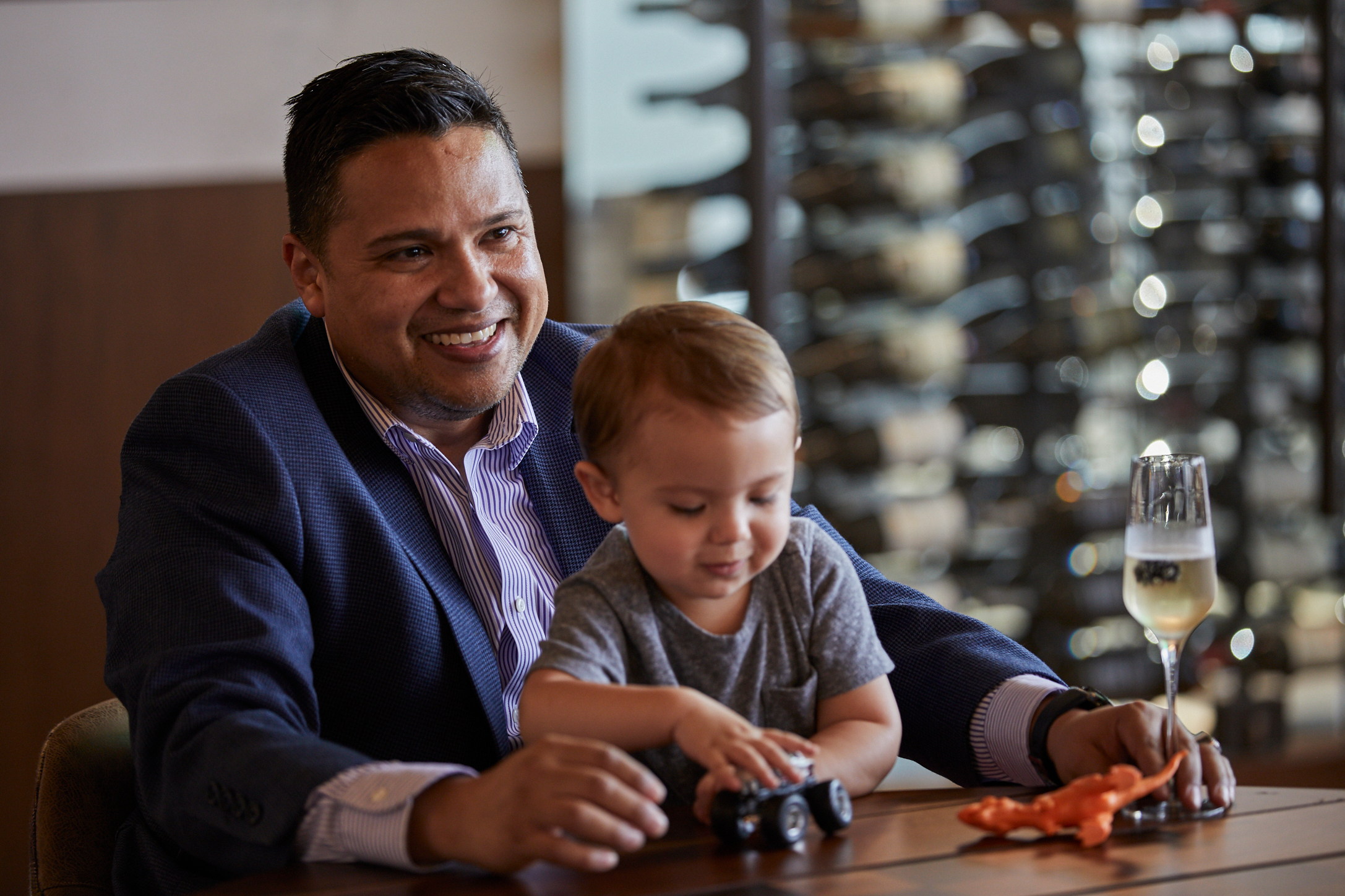 Man seated with son on lap