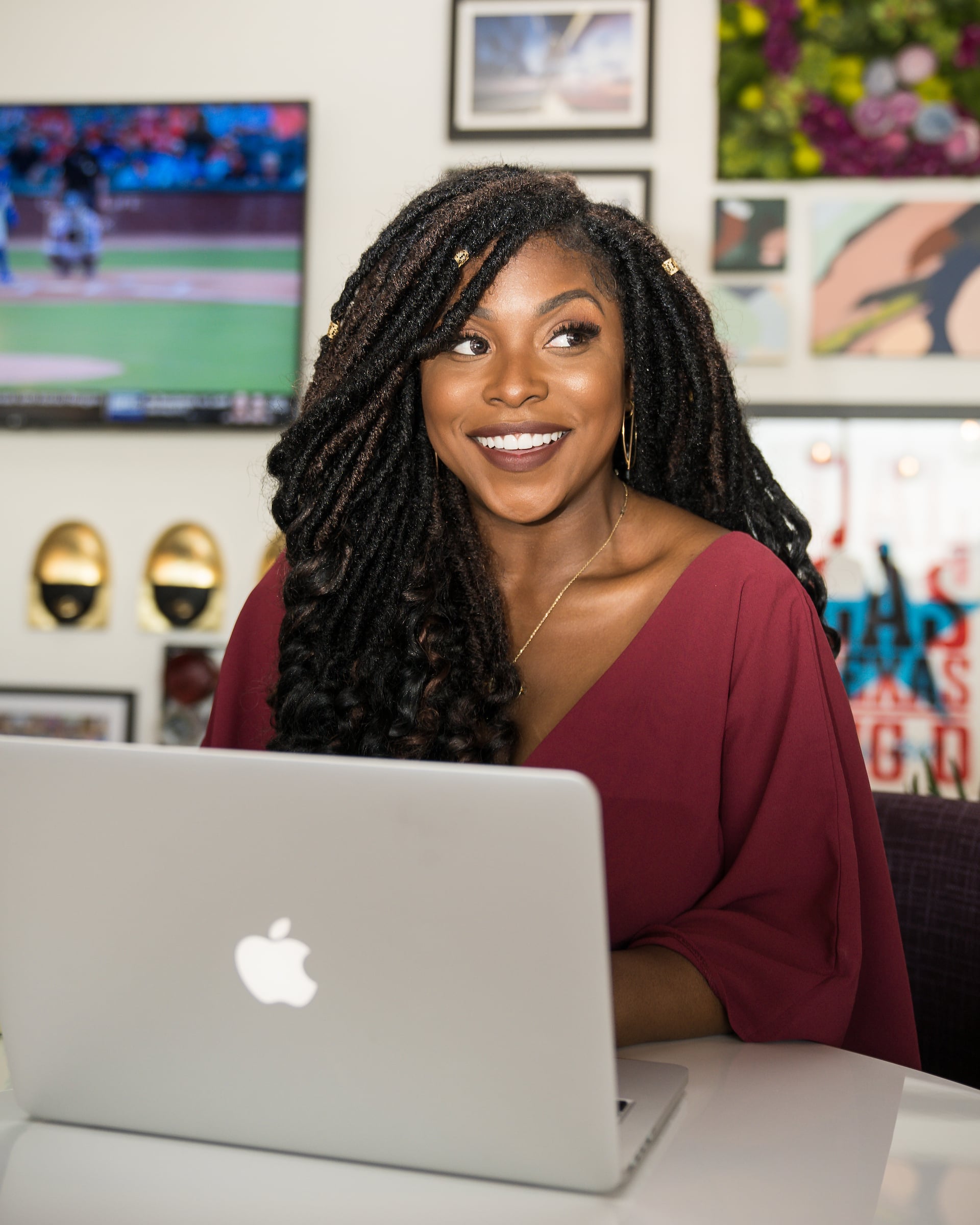 Woman smiling with her computer open in front of her