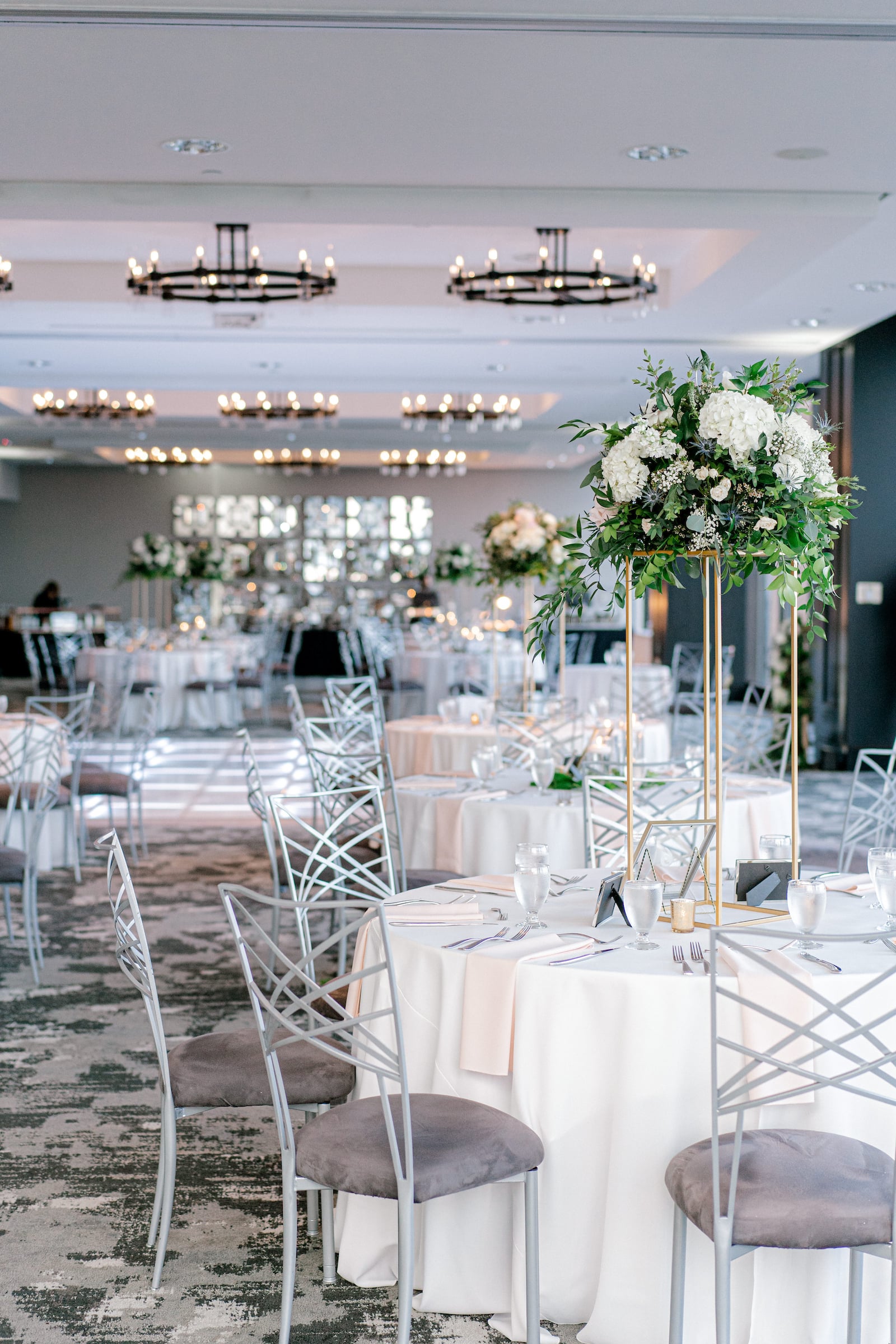Wedding reception ballroom set up with tables & flowers