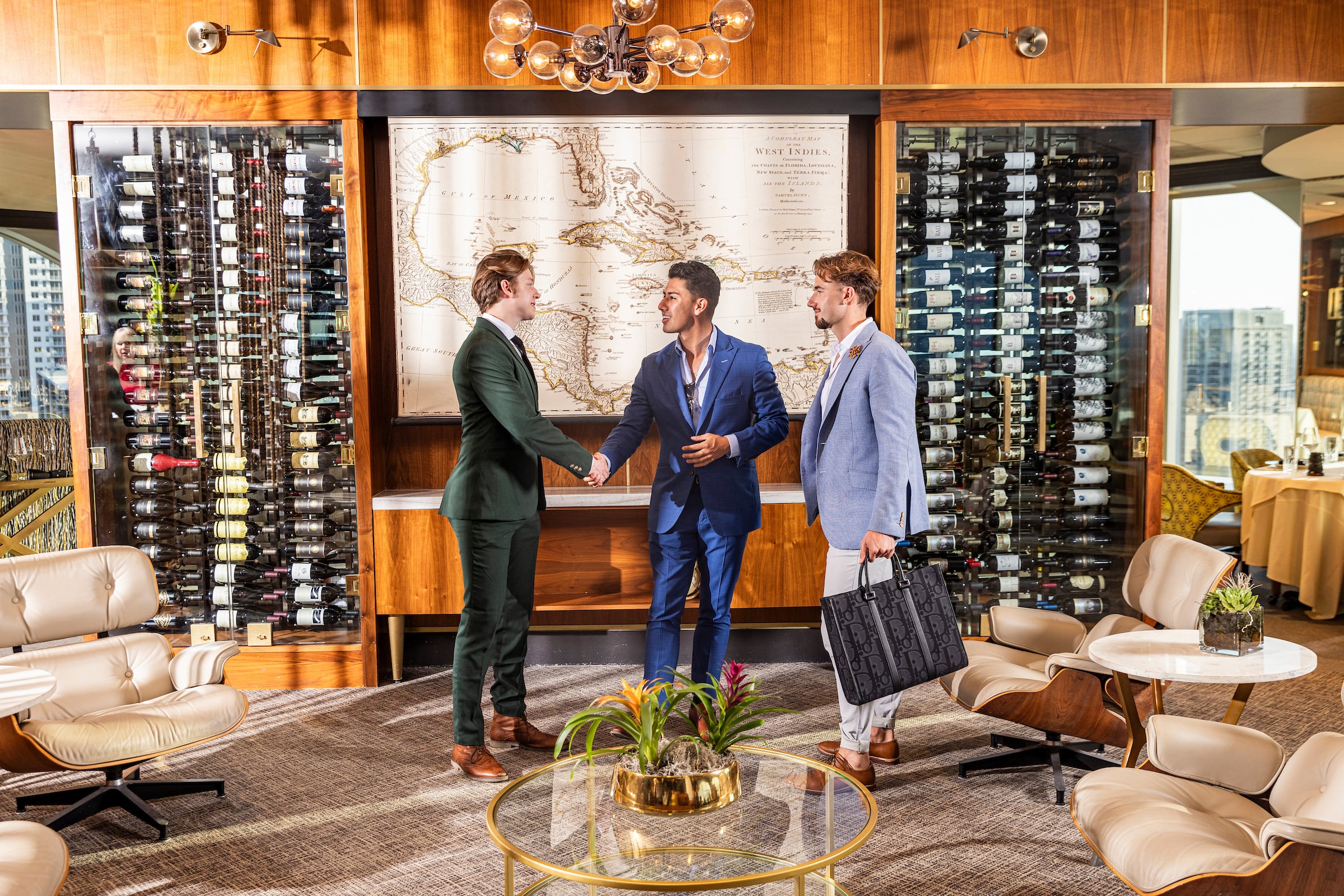 Three men meeting in the lobby at Tower Club Ft Lauderdale