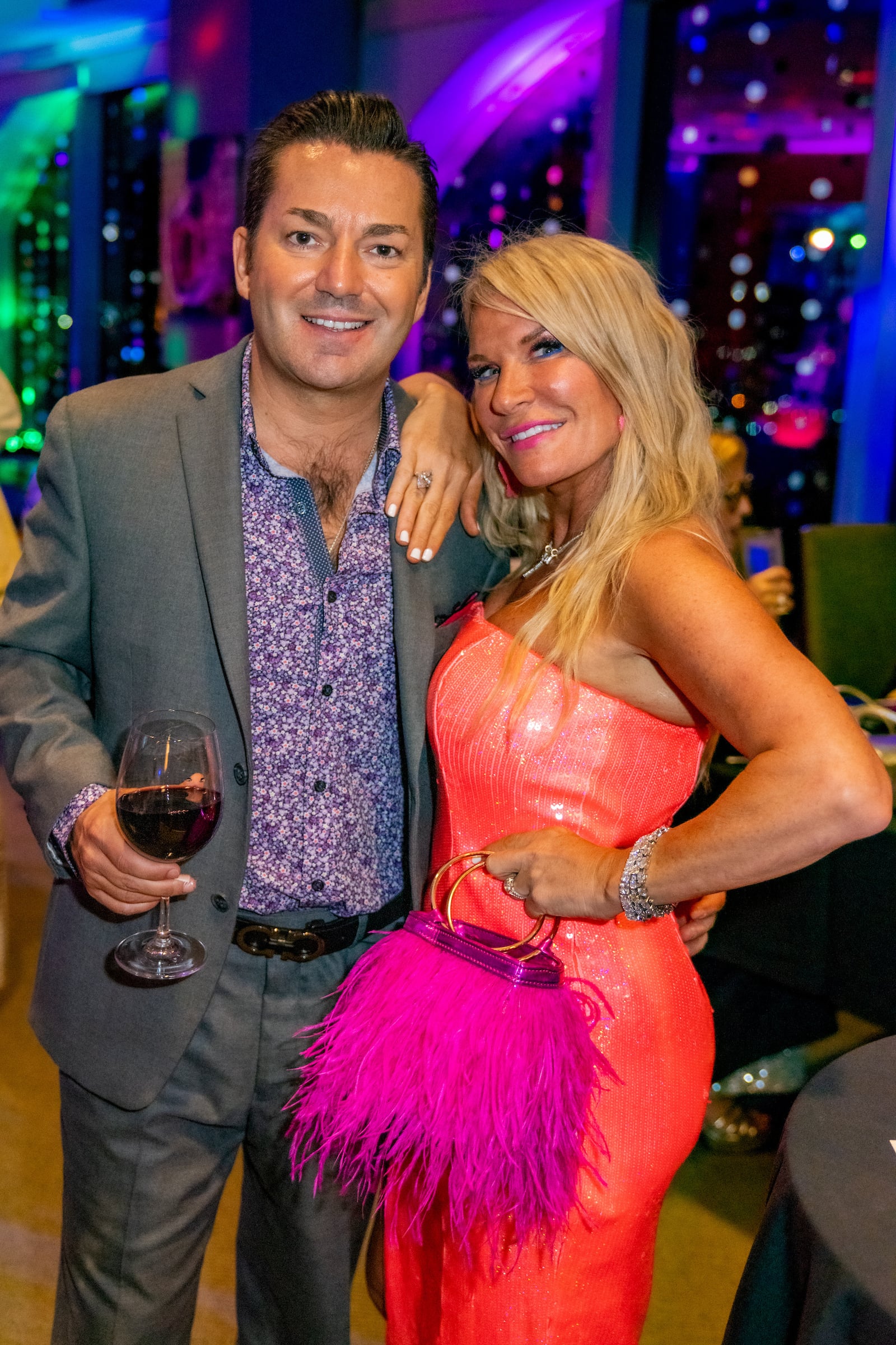Man & woman posing at a private event