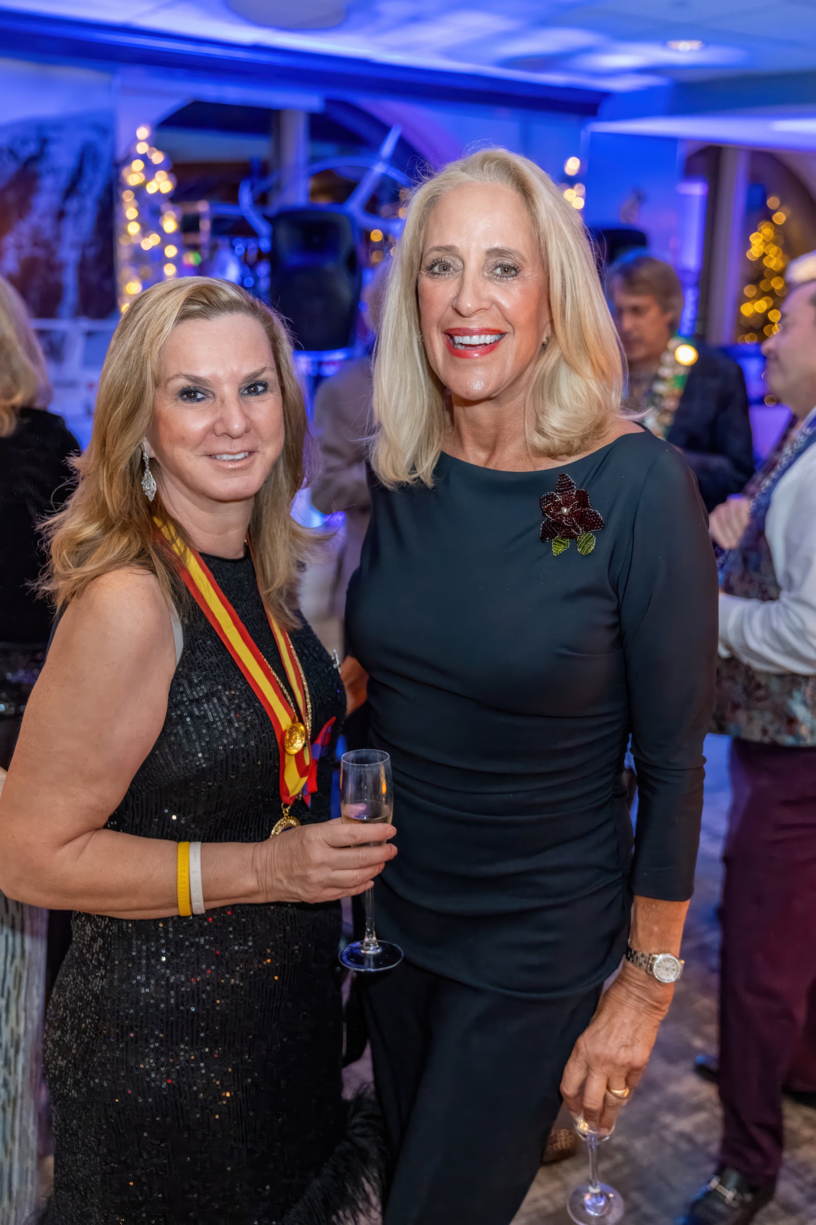 Two women posing at a private event