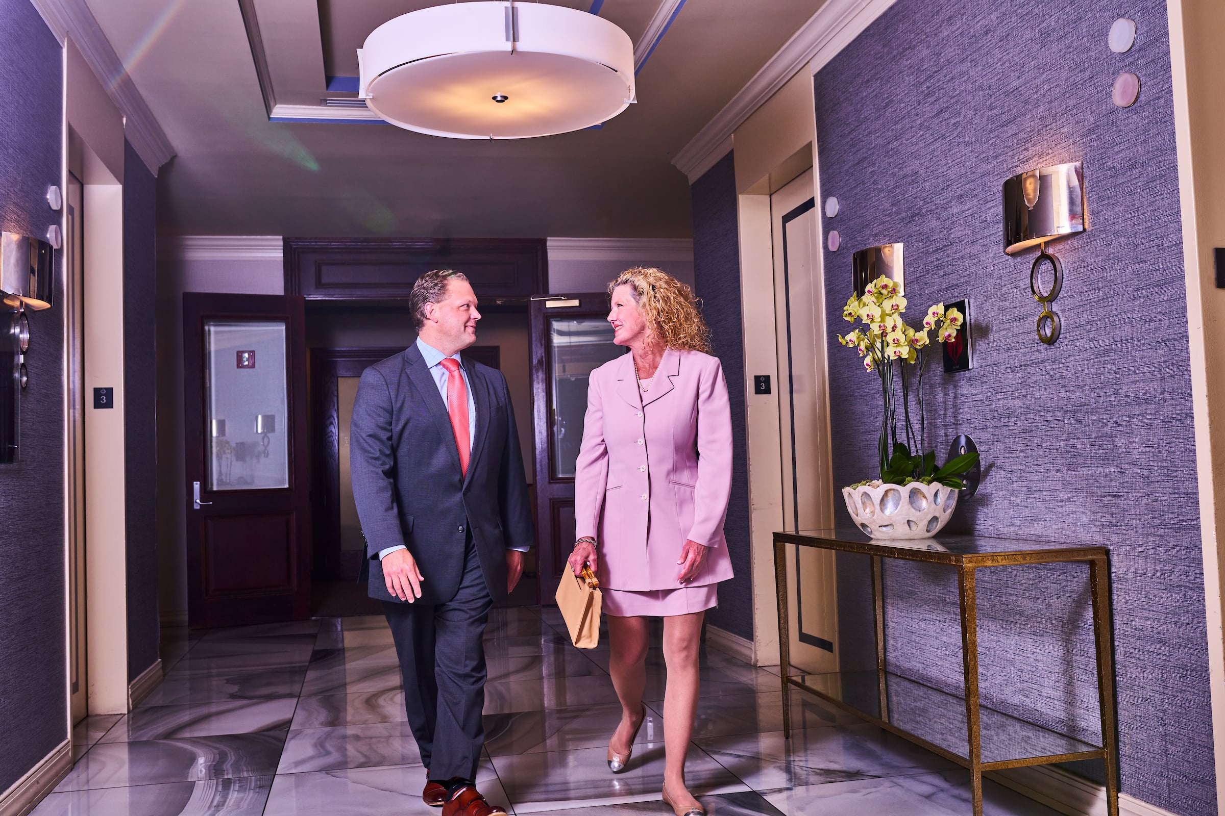 Man & Woman walking in Town Point Club lobby