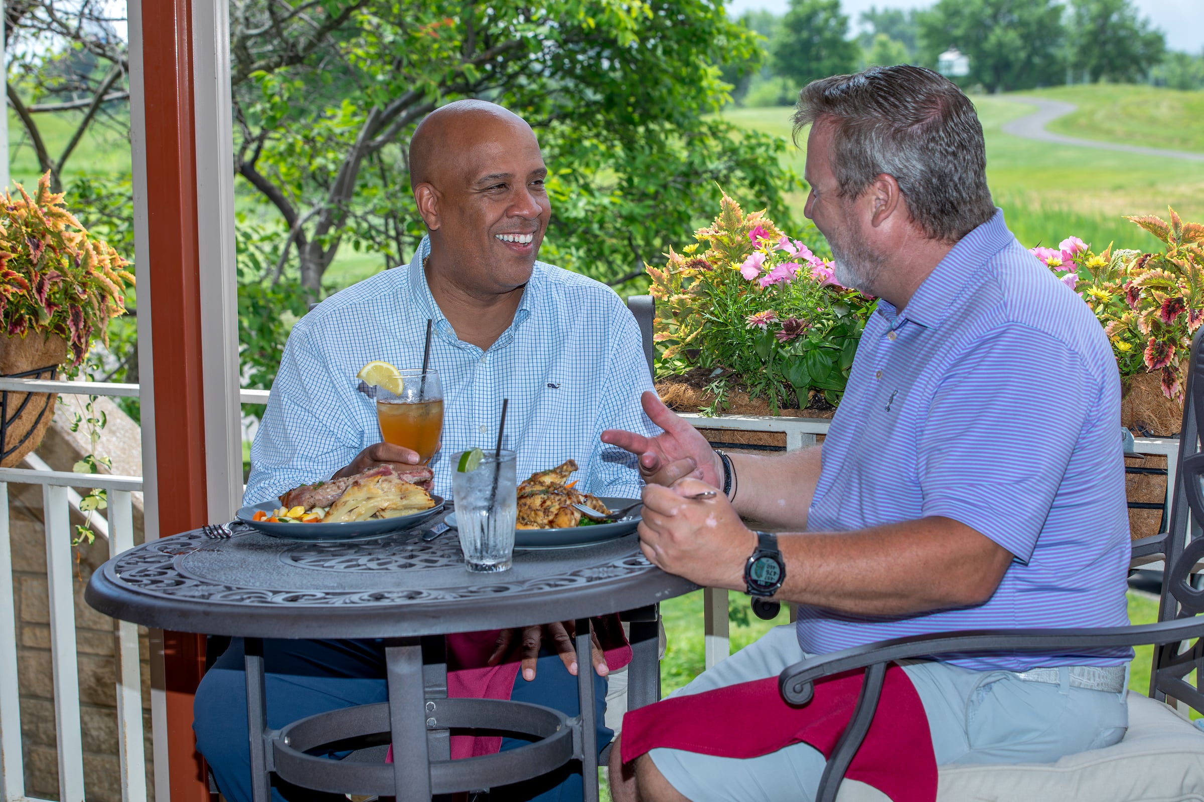 two men dining enjoying drinks