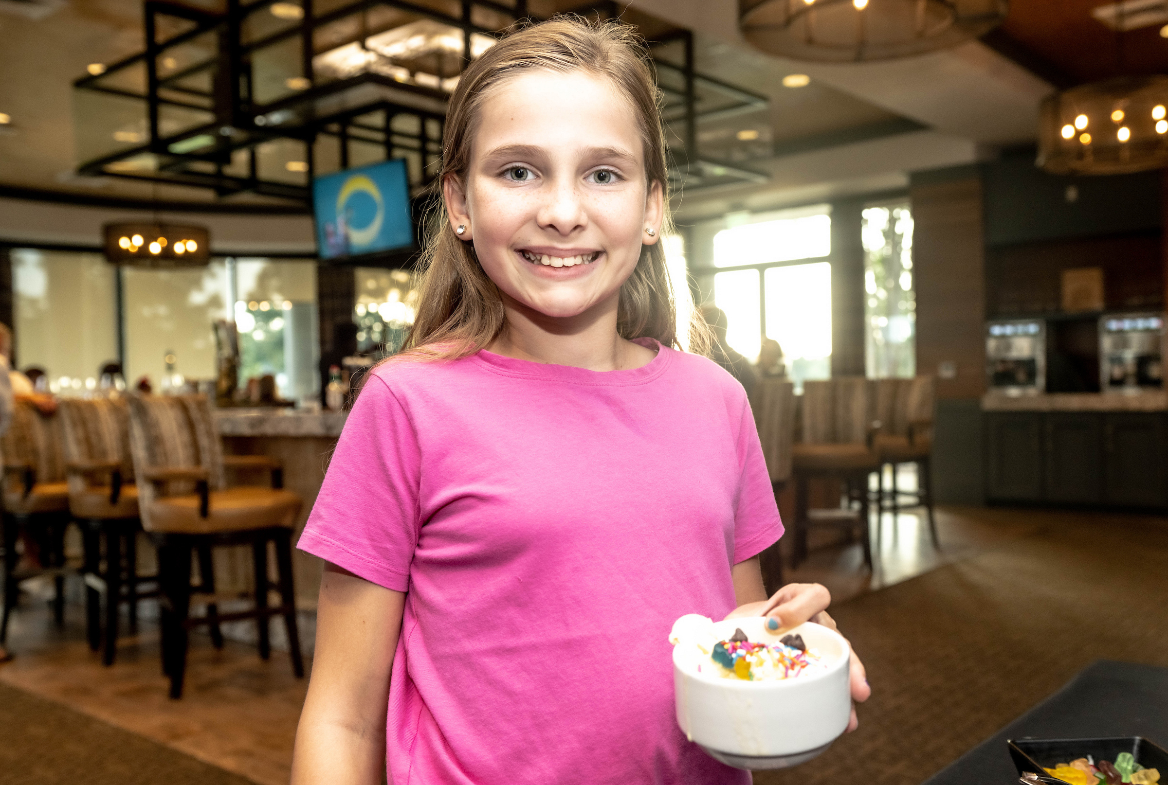 Child holding a birthday cake
