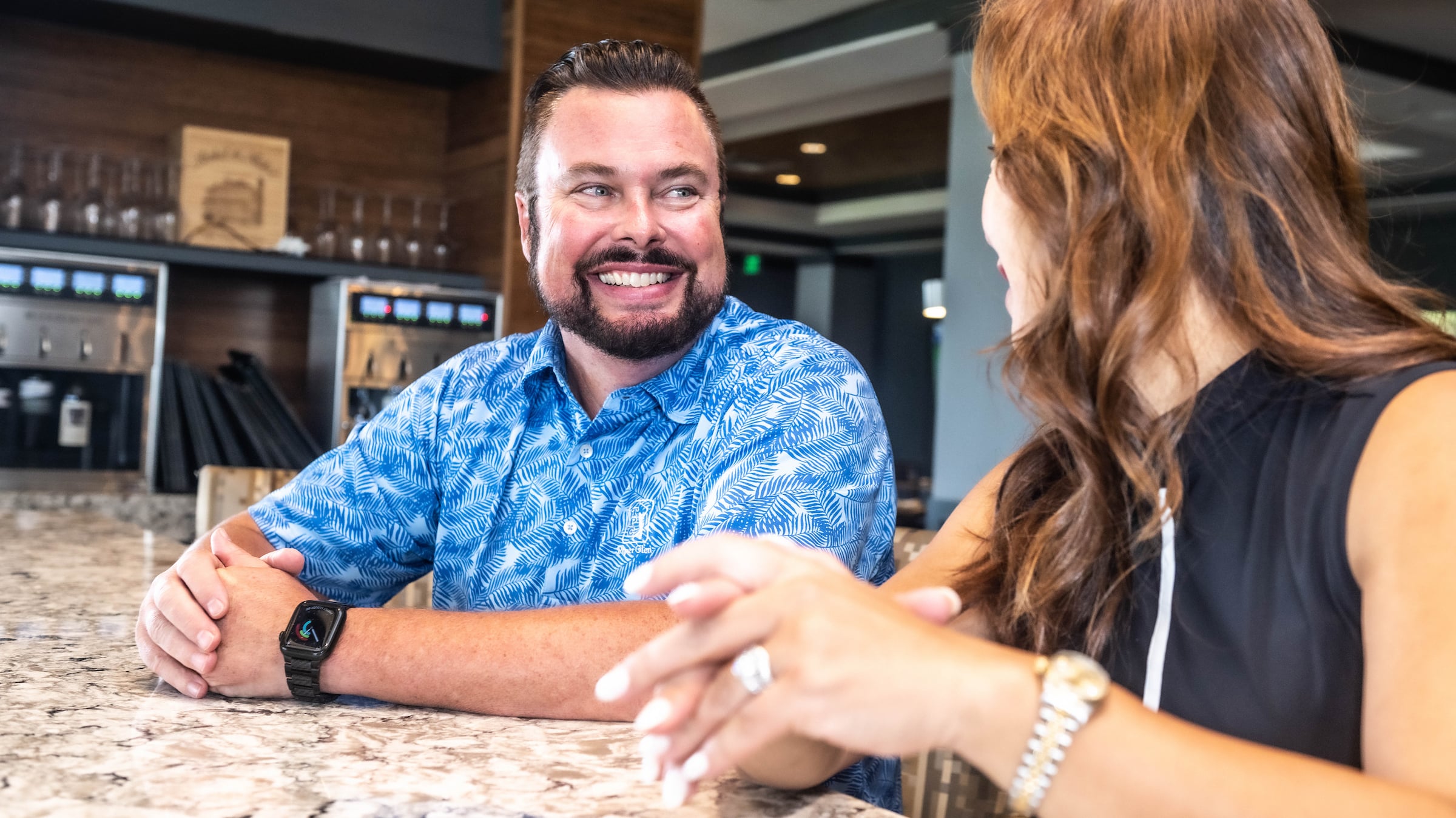 Man and woman sitting at a bar