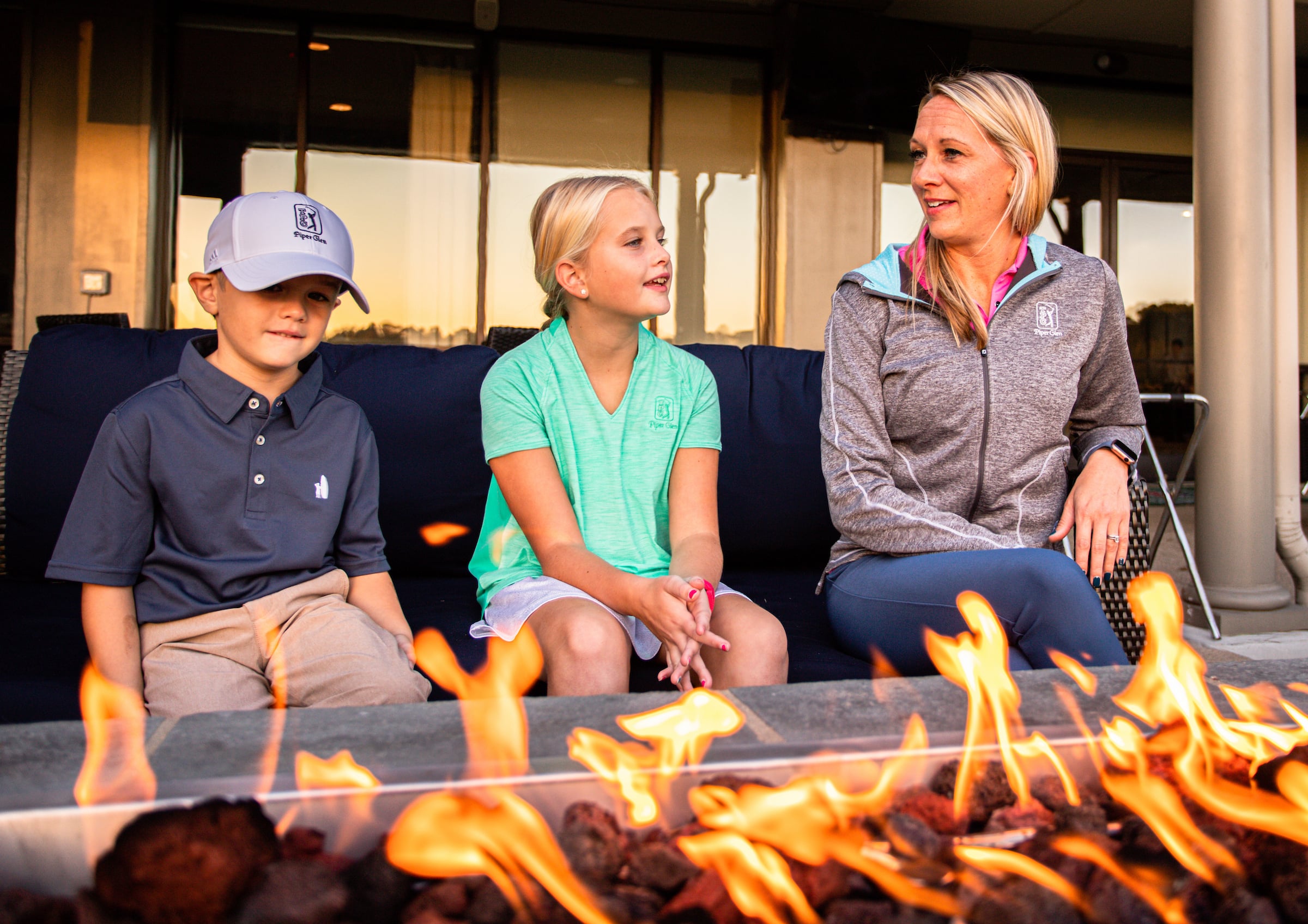 Mother and two children sitting by a fire pit