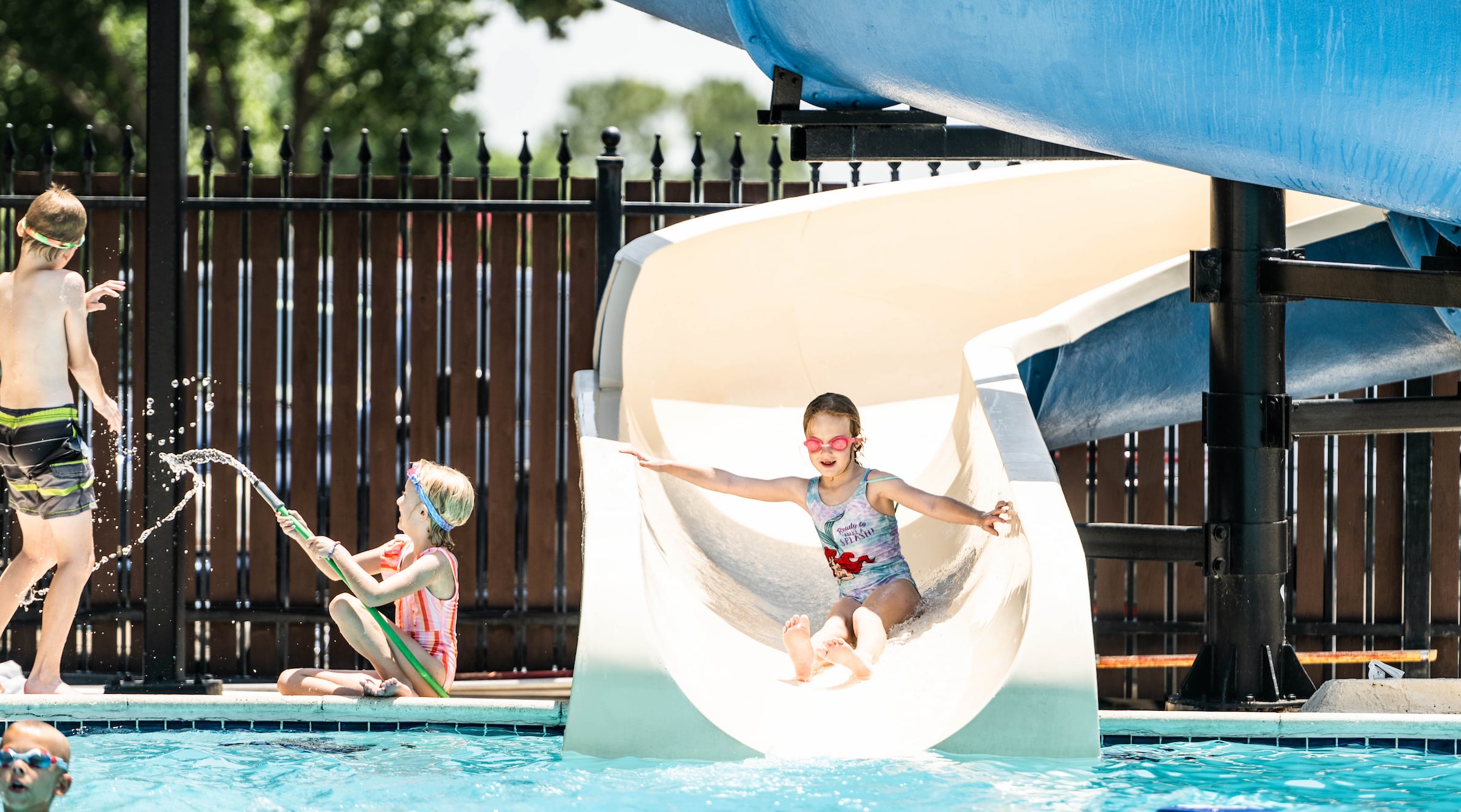 Walnut Creek Country Club - Child coming down pool slide